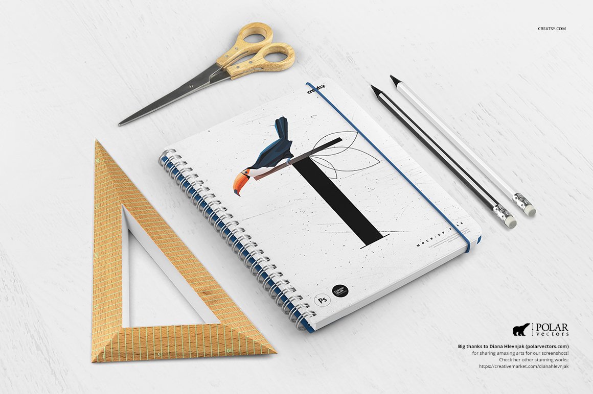 White mockup notebook with toucan, scissors, white and black pencil and triangular ruler on a white background.