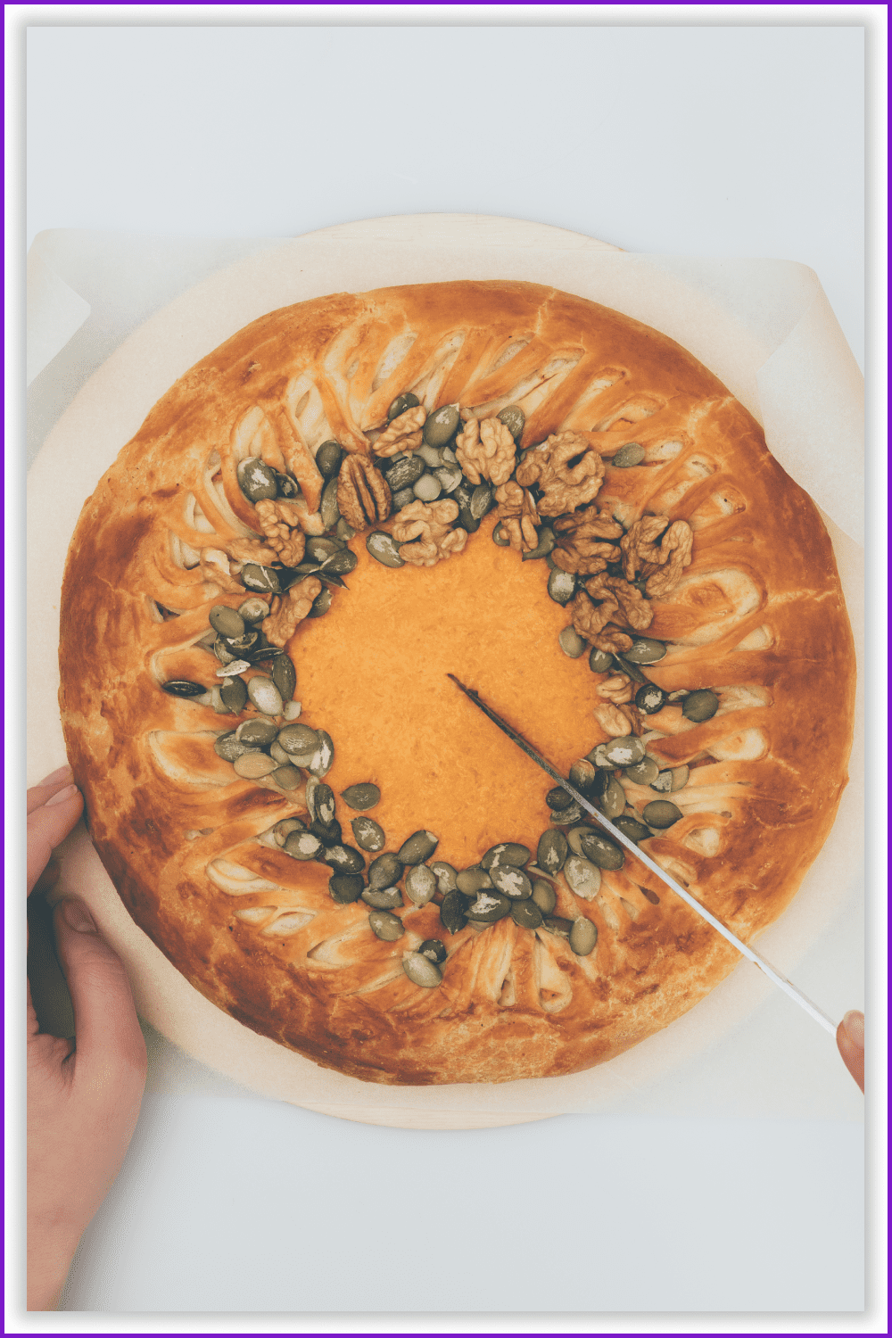 Hand with a knife cuts a pumpkin pie.