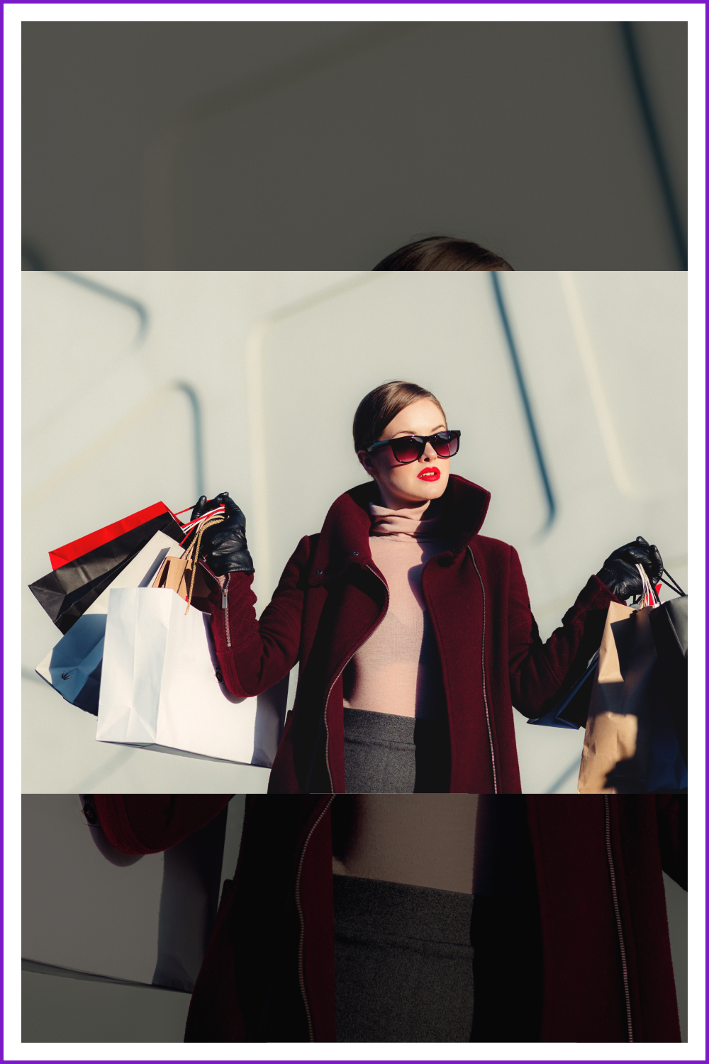 Woman in sunglasses with shopping bags.