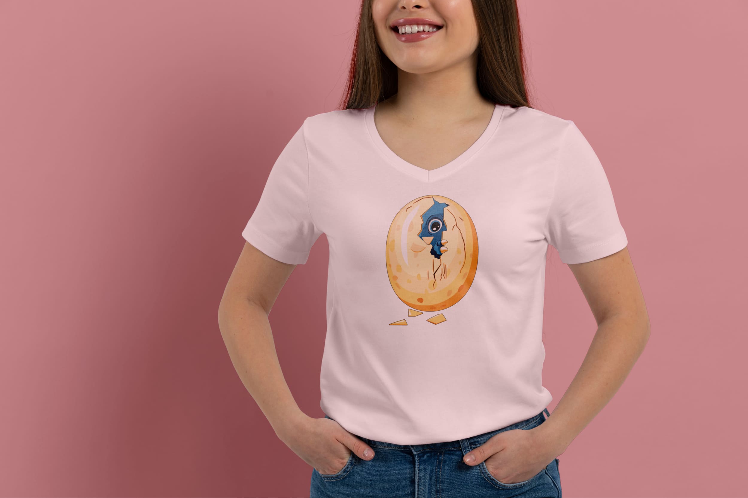 Light pink T-shirt on a girl with a blue dragon in an egg, on a pink background.