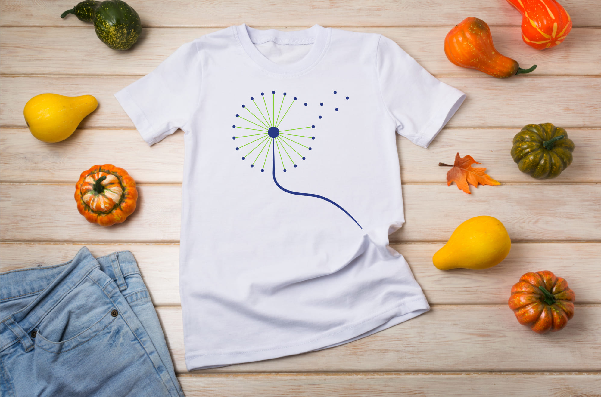 White T-shirt with a blue dandelion flower and pumpkins.