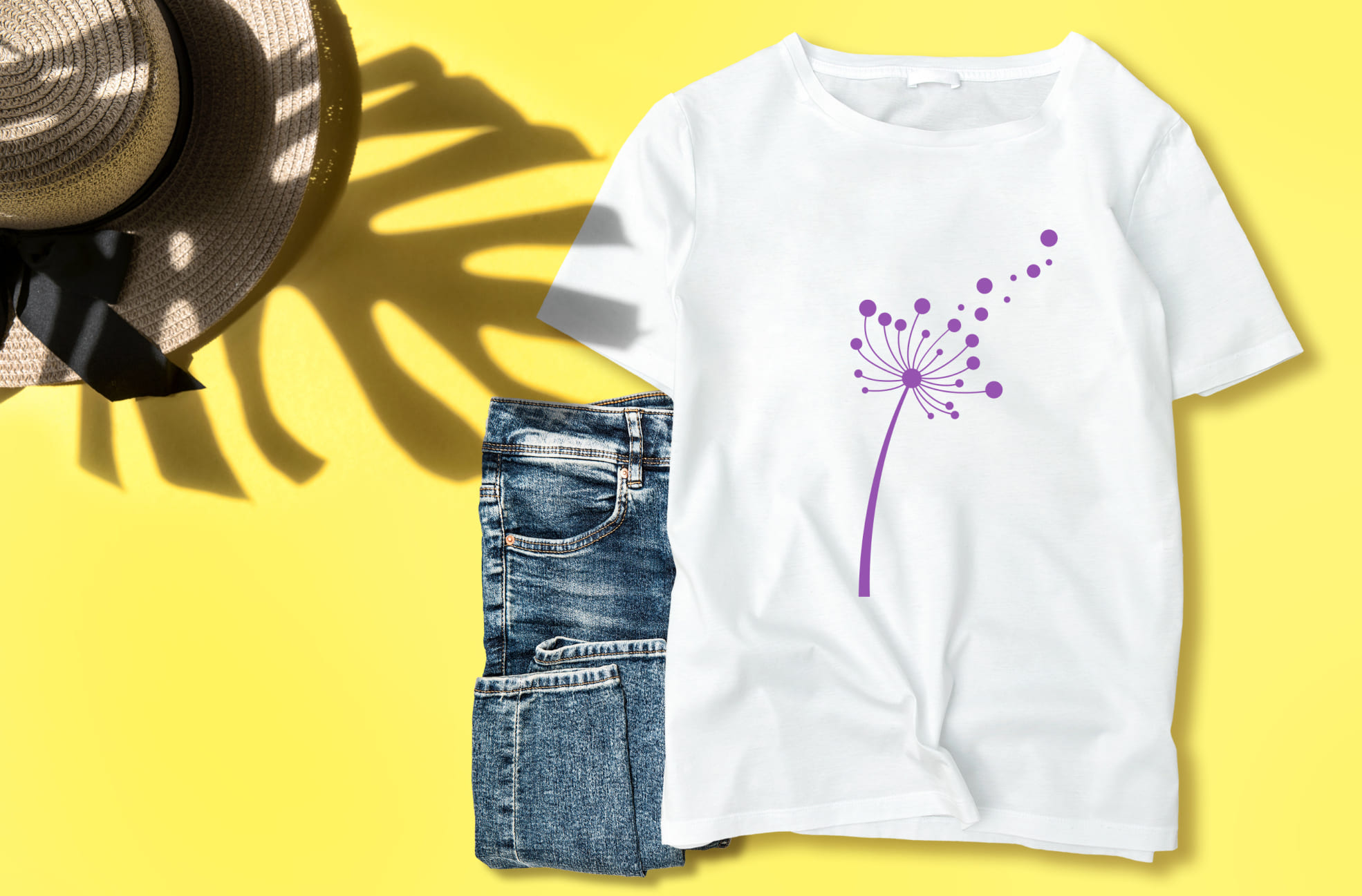 Image of a t-shirt with colorful dandelion print in purple.
