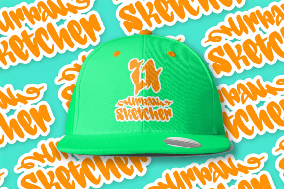 A green cap with a orange "Urban Sketcher" lettering in graffiti font on a graffiti background.