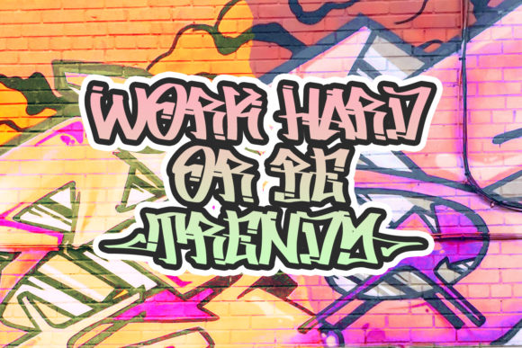 Pink and green "Work hard or be trendy" lettering in graffiti font on a graffiti background.