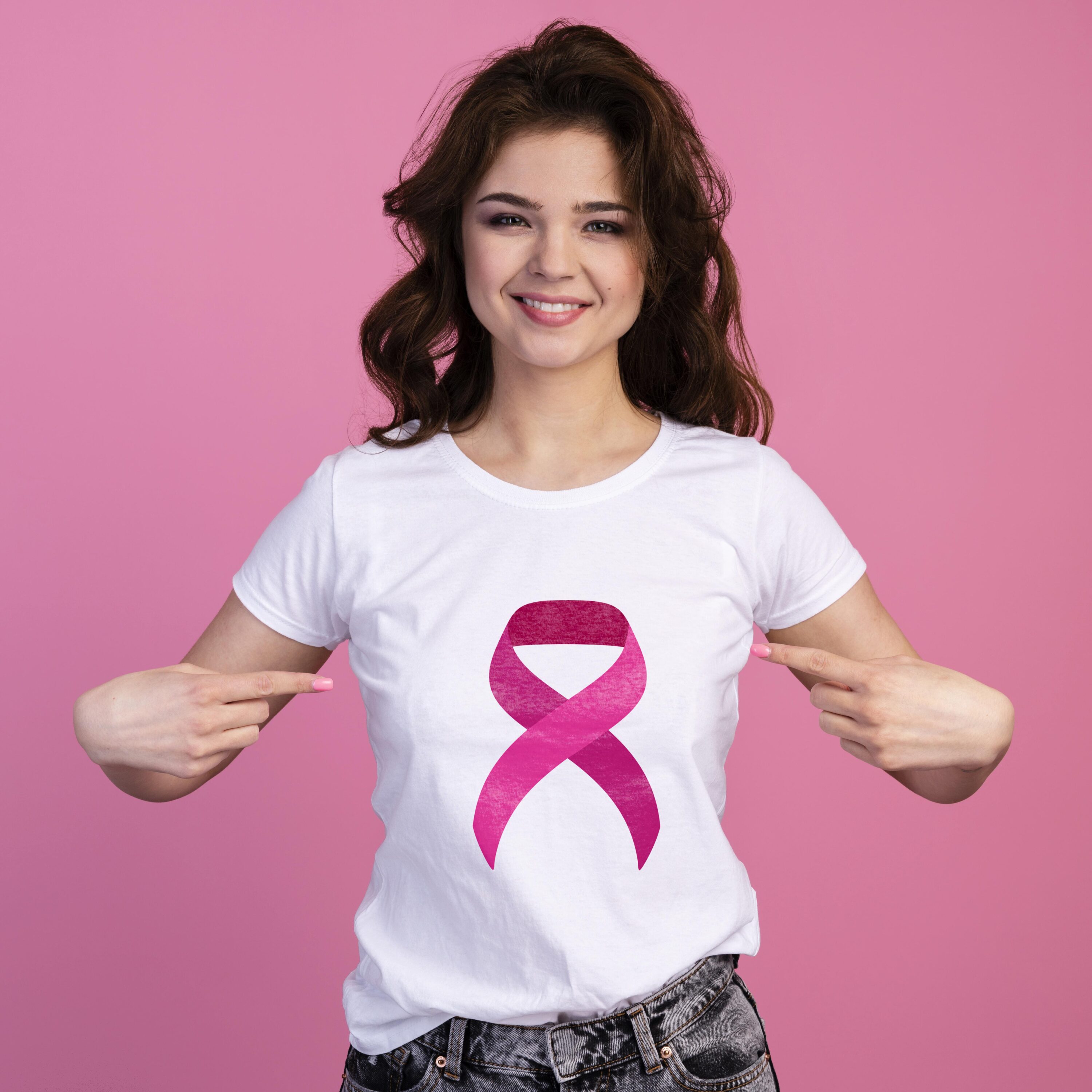 Big pink breast cancer ribbon on the white t-shirt.