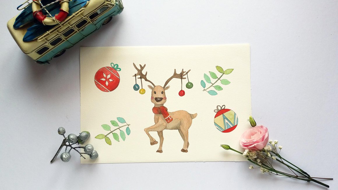 Drawing with a reindeer, 2 leaves and 2 christmas balls on a beige landscape sheet.