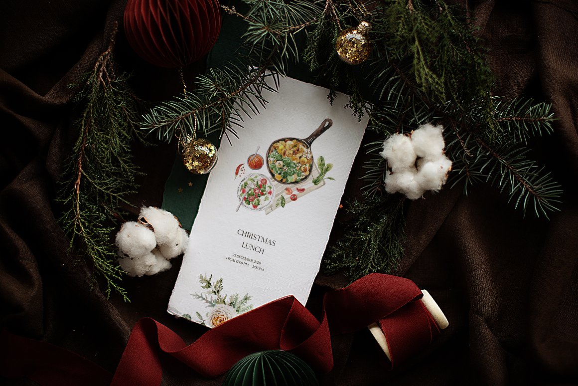 A white card with black lettering "Christmas lunch" and christmas illustrations.