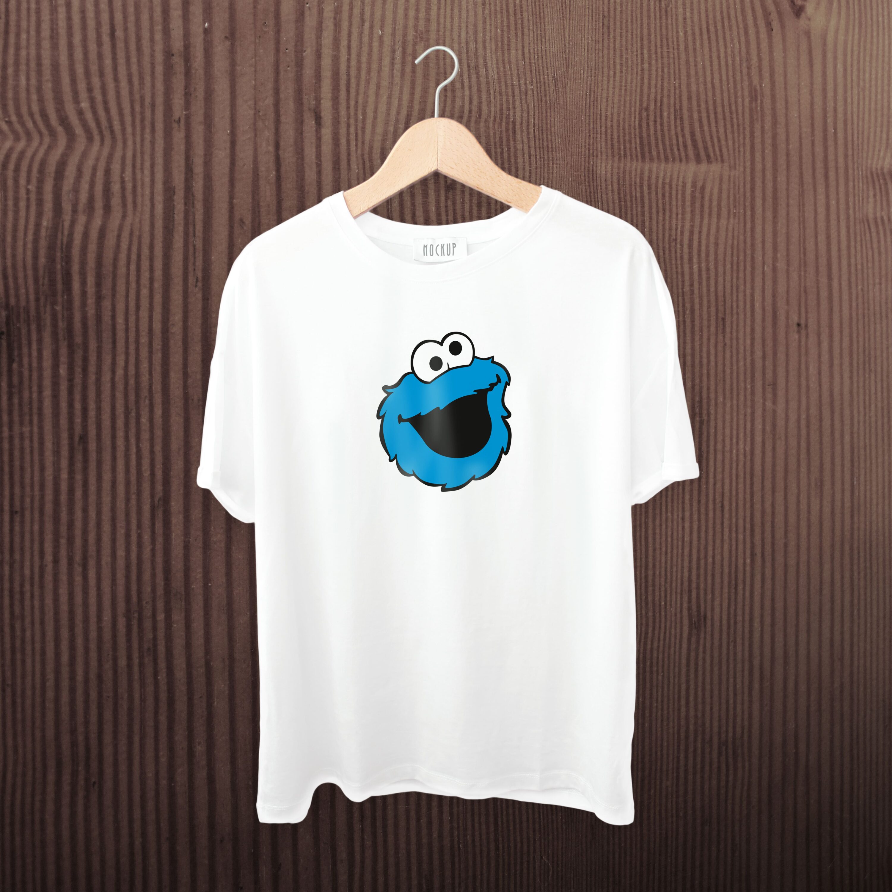 A white t-shirt with a smiling cookie monster face.