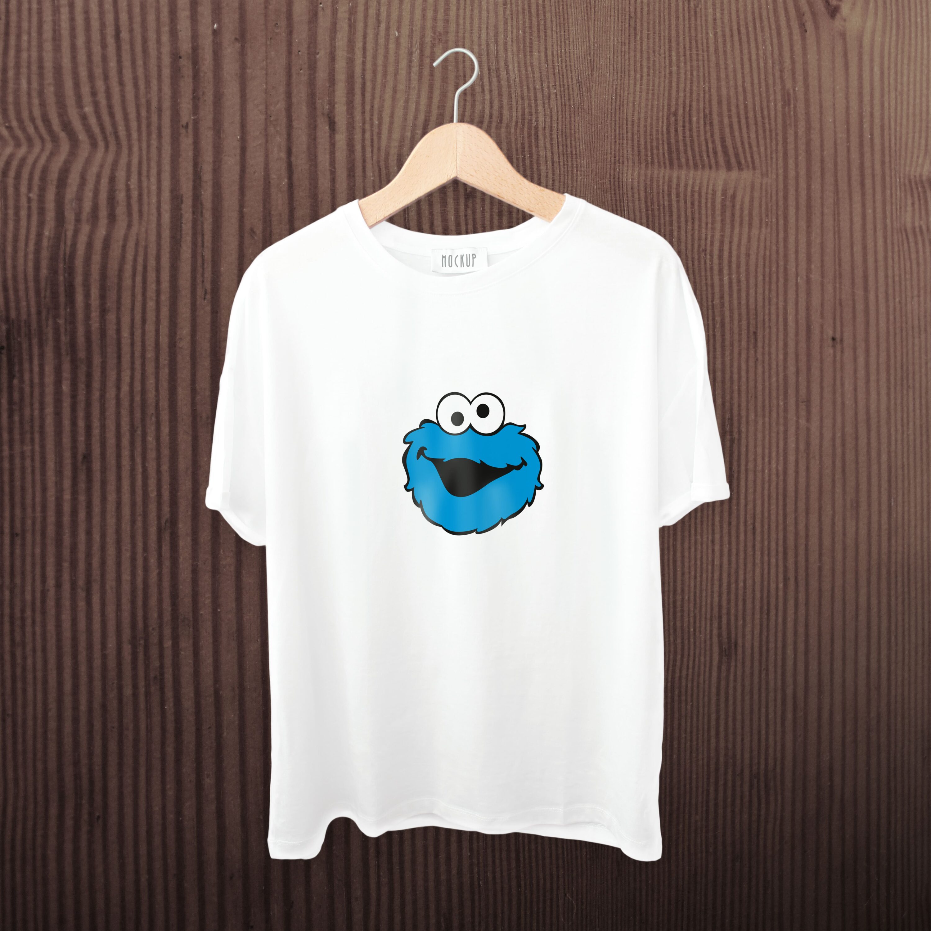 A white t-shirt with a smiling cookie monster face.