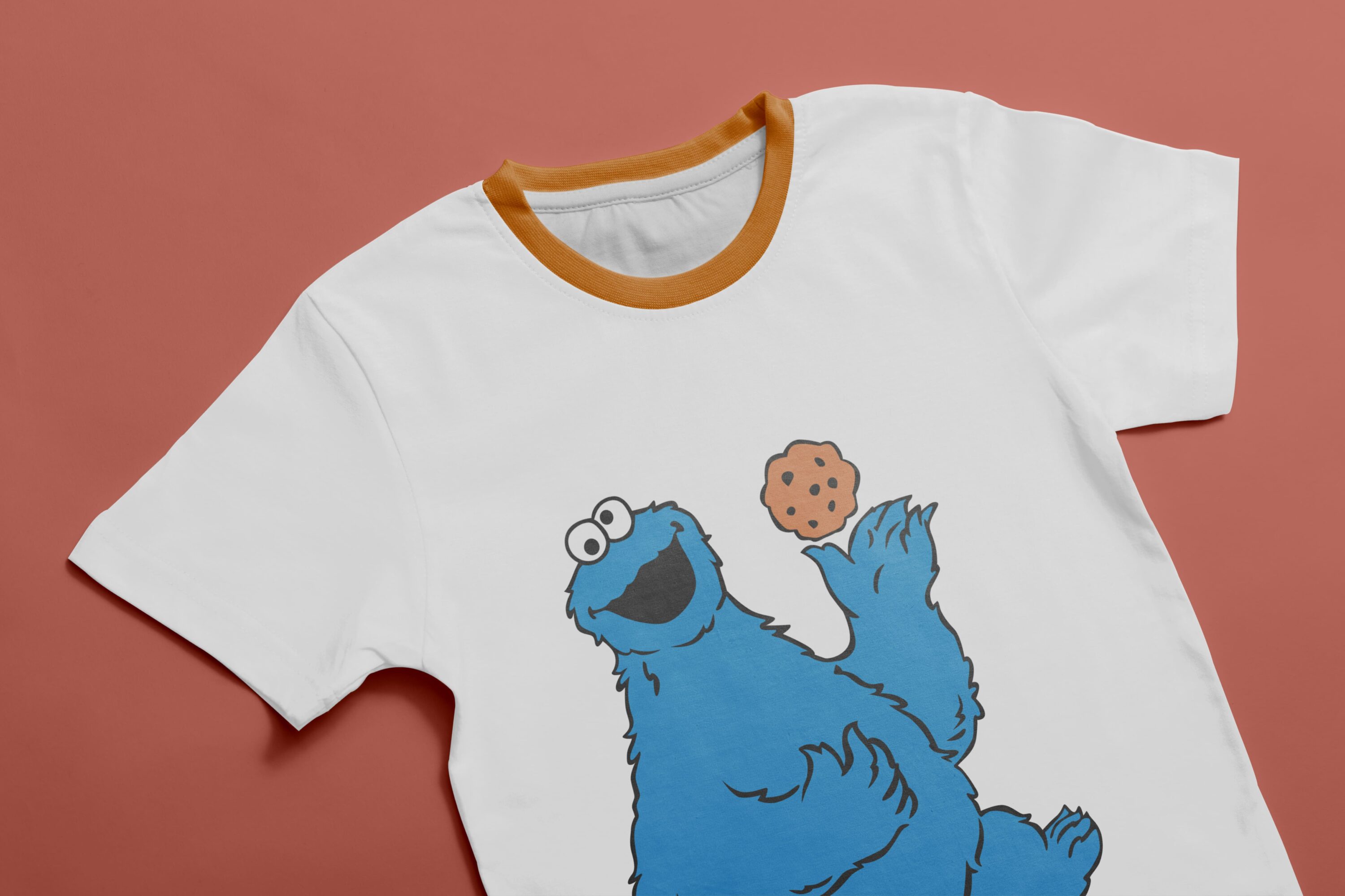 White T-shirt with orange collar and an image of a character - Cookie Monster, holding a cookie.