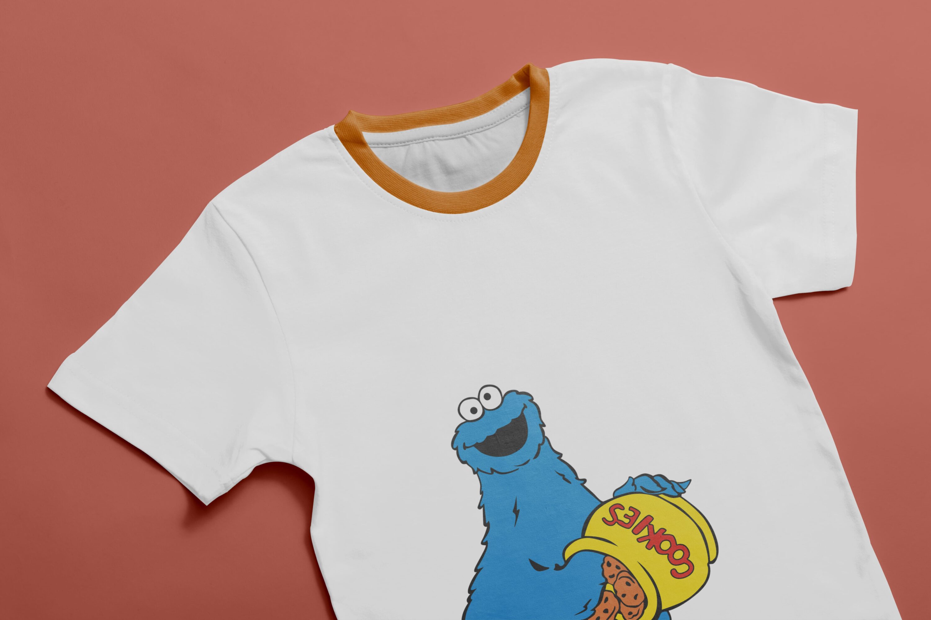 White T-shirt with orange collar and an image of a character - Cookie Monster, holding a yellow cookie jar.