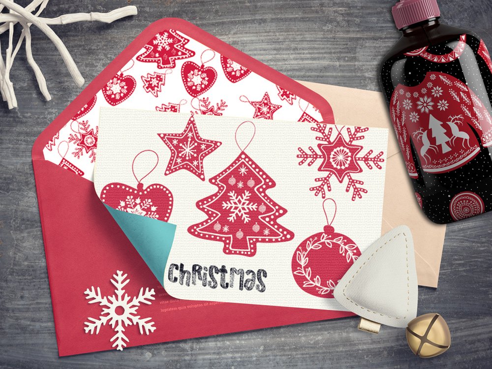 A white card with black lettering "Christmas" and red different christmas illustrations on an envelope.