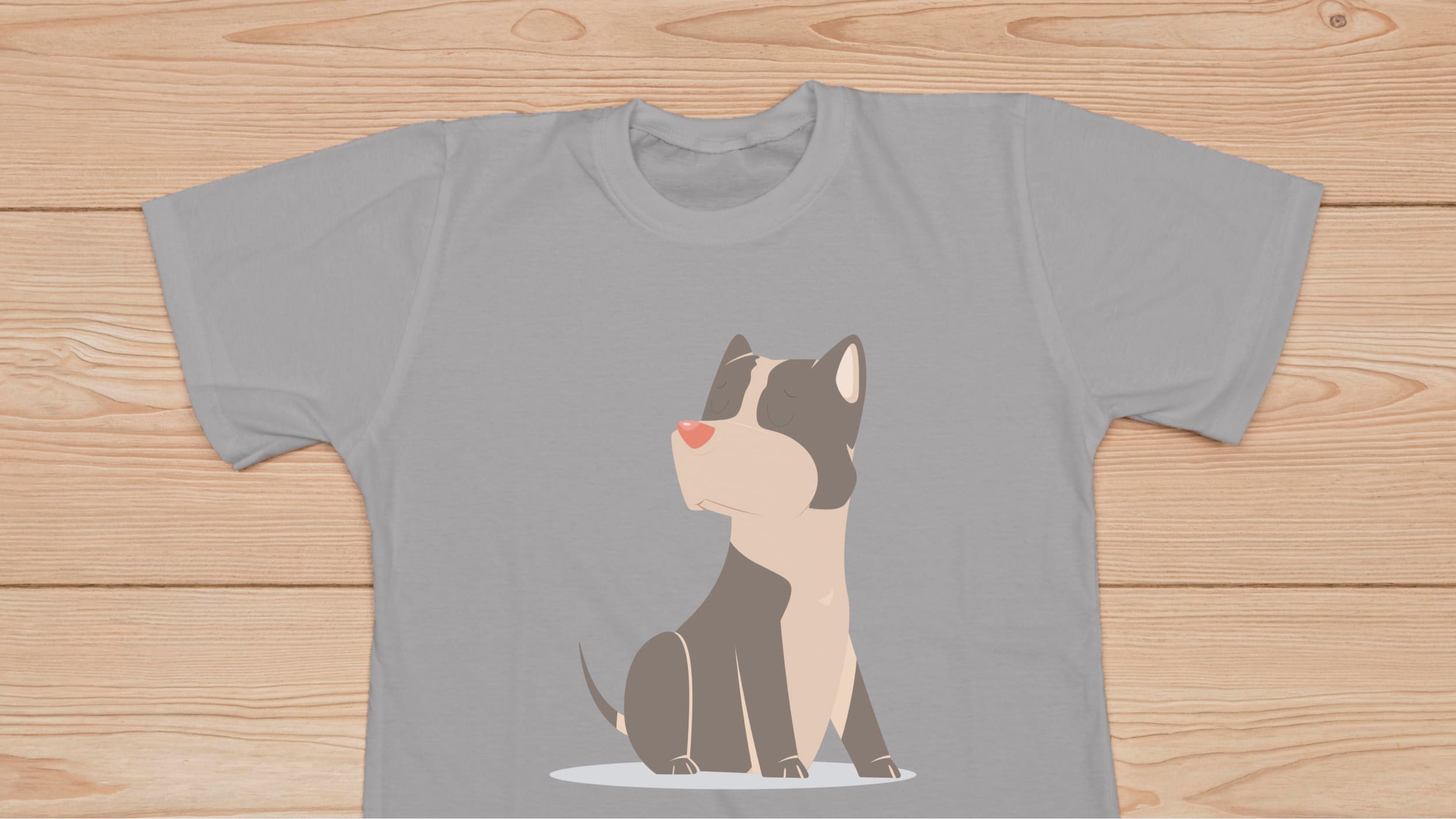 Gray t-shirt with a cute black pitbull on the wooden background.