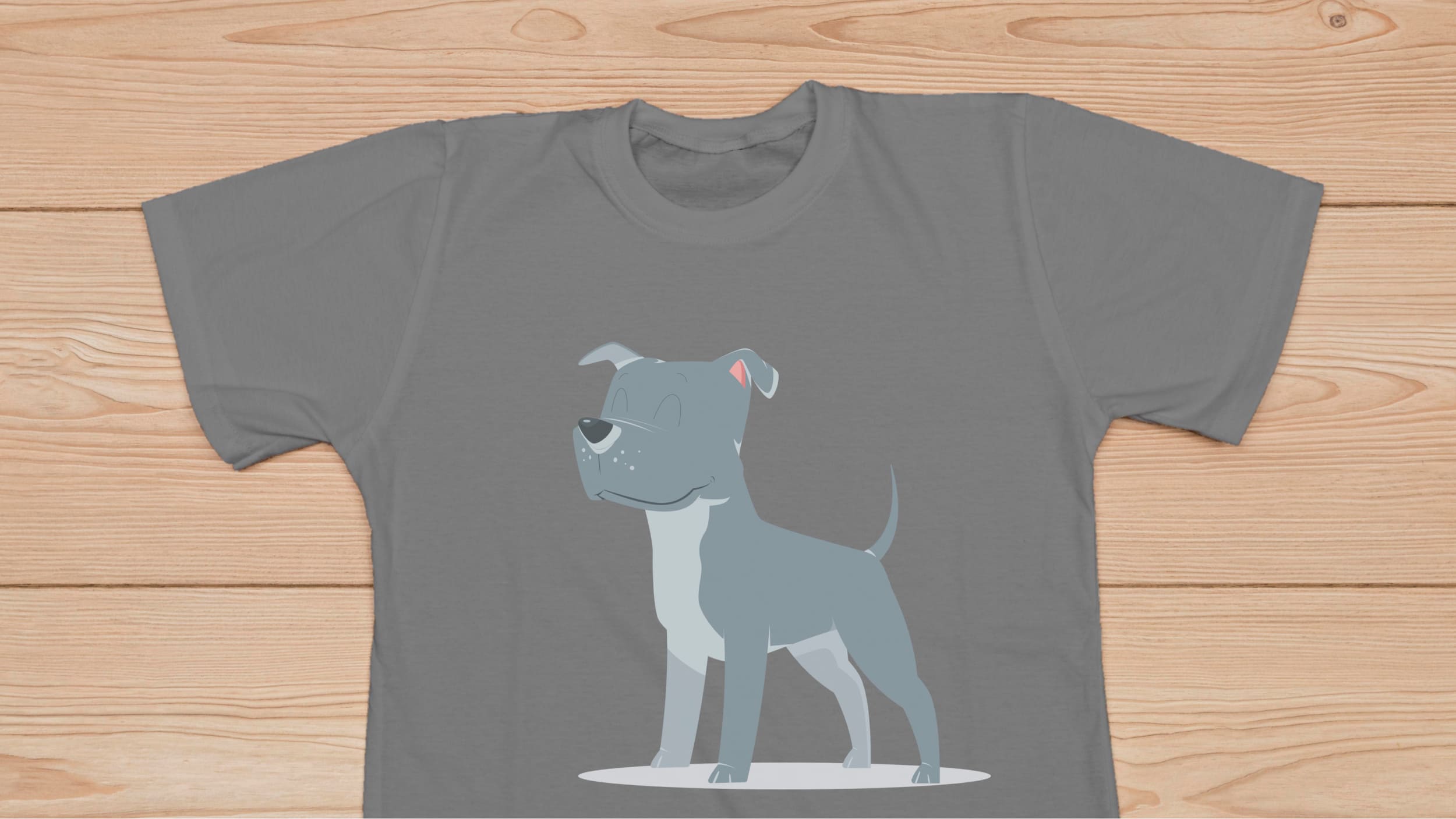 Gray t-shirt with a cute gray pitbull on the wooden background.