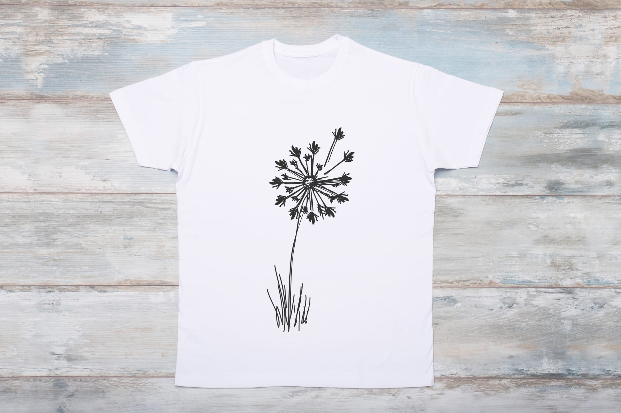 Image of white t-shirt with enchanting dandelion print.