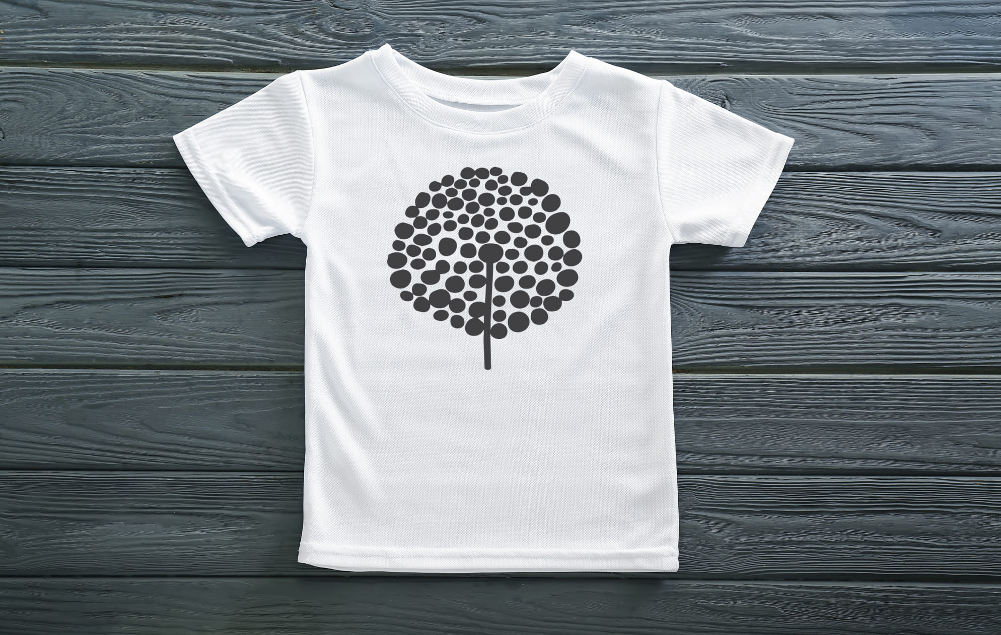 White t-shirt with a black silhouette of a dandelion.