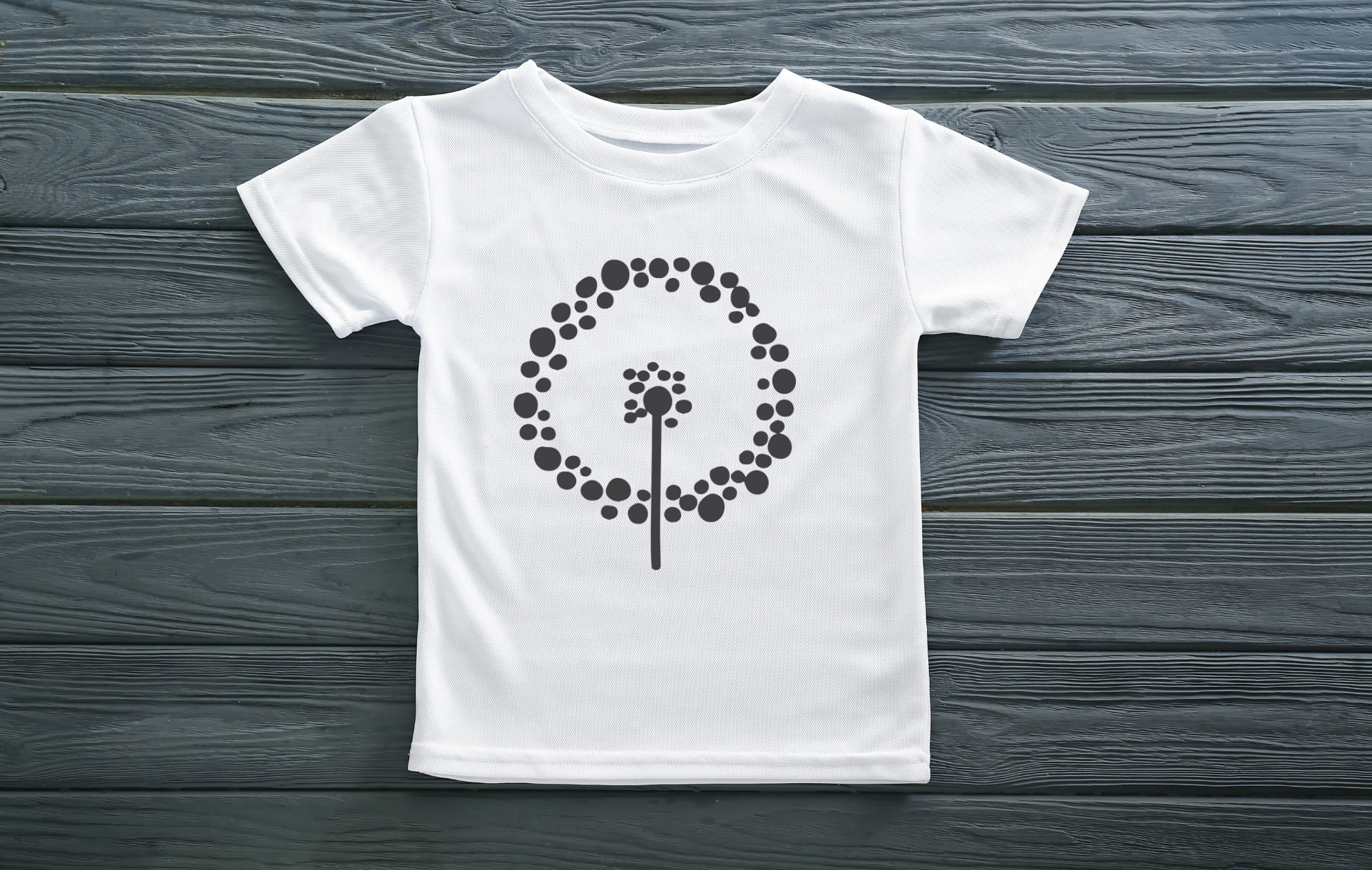 White t-shirt with a black silhouette of a dandelion.