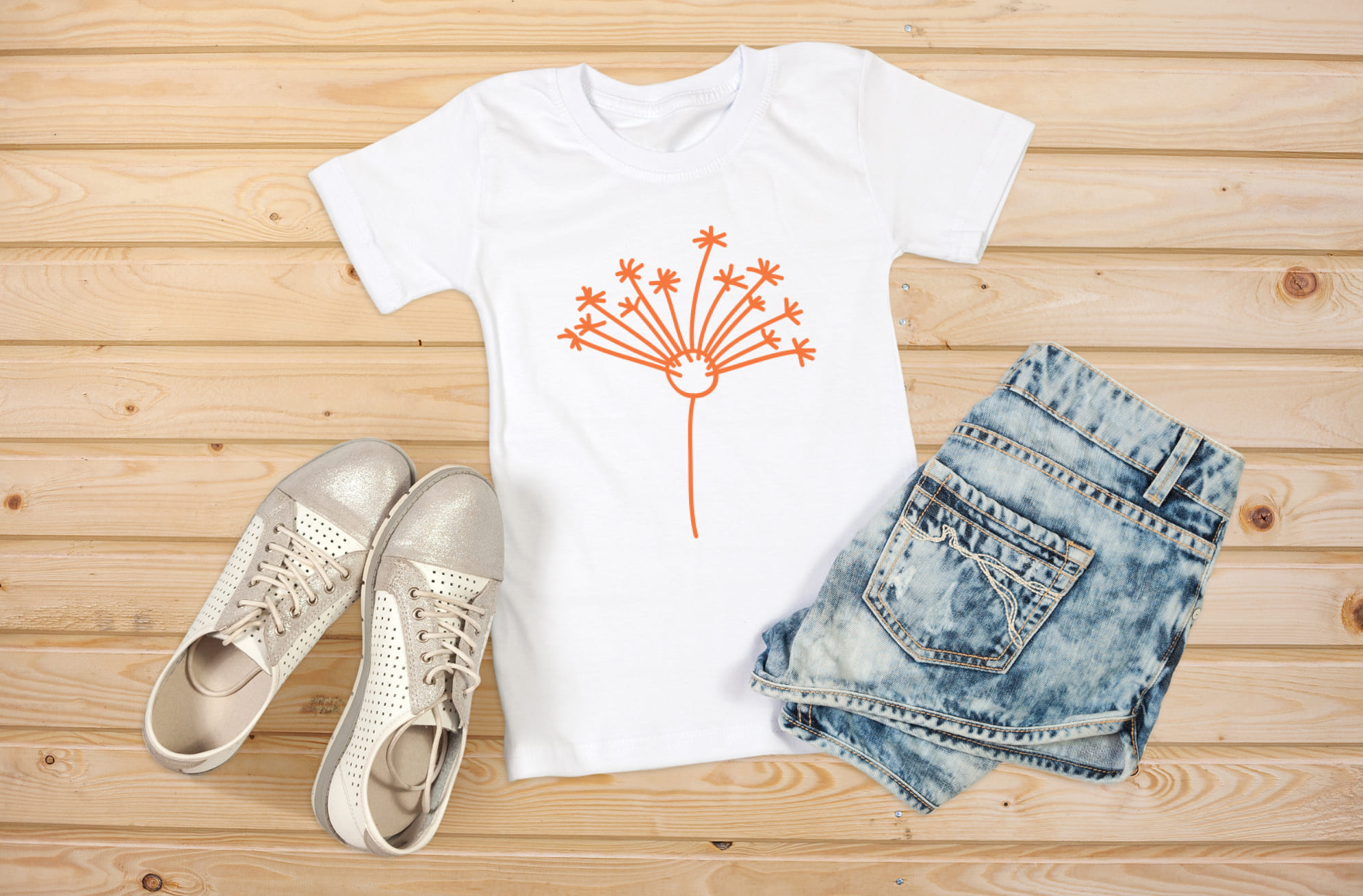 T-shirt image with enchanting orange dandelion print.