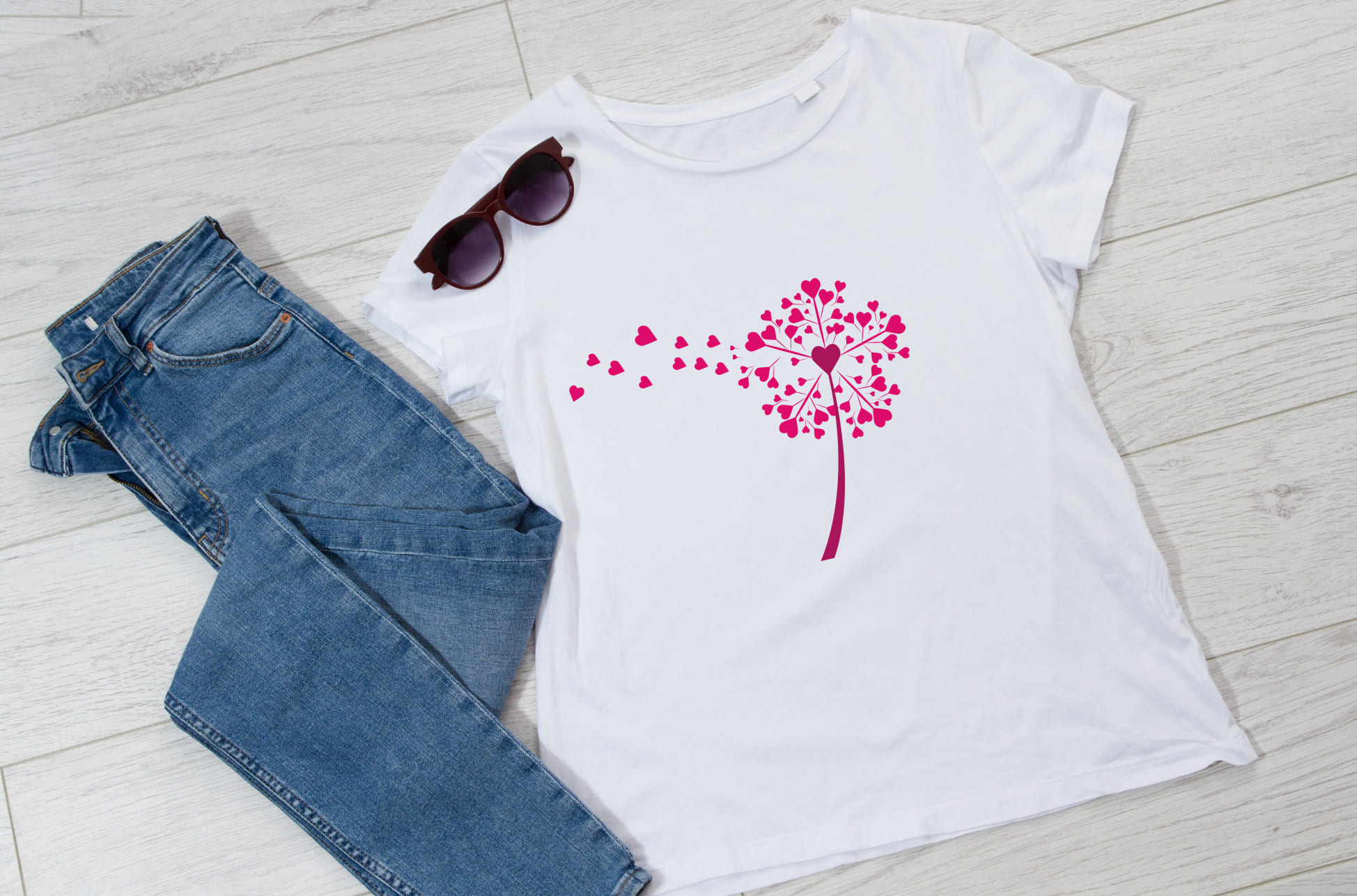 White T-shirt with pink dandelion flower and sunglasses with jeans.