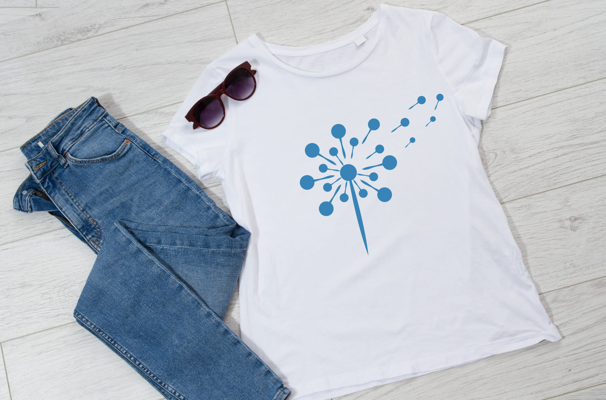 White T-shirt with blue dandelion flower and sunglasses with jeans.