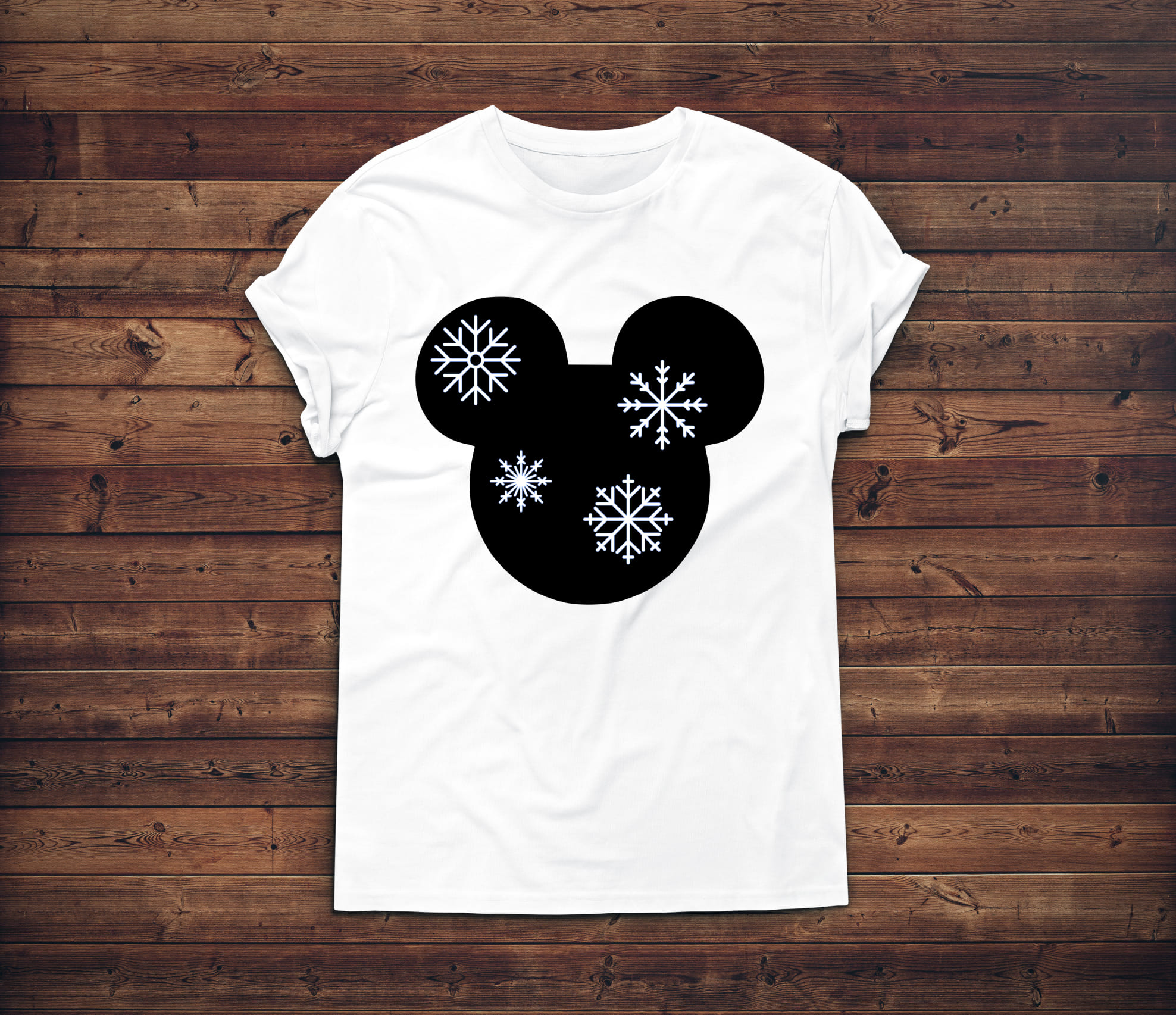 Cute mickey mouse face with the snowflakes on a white t-shirt.