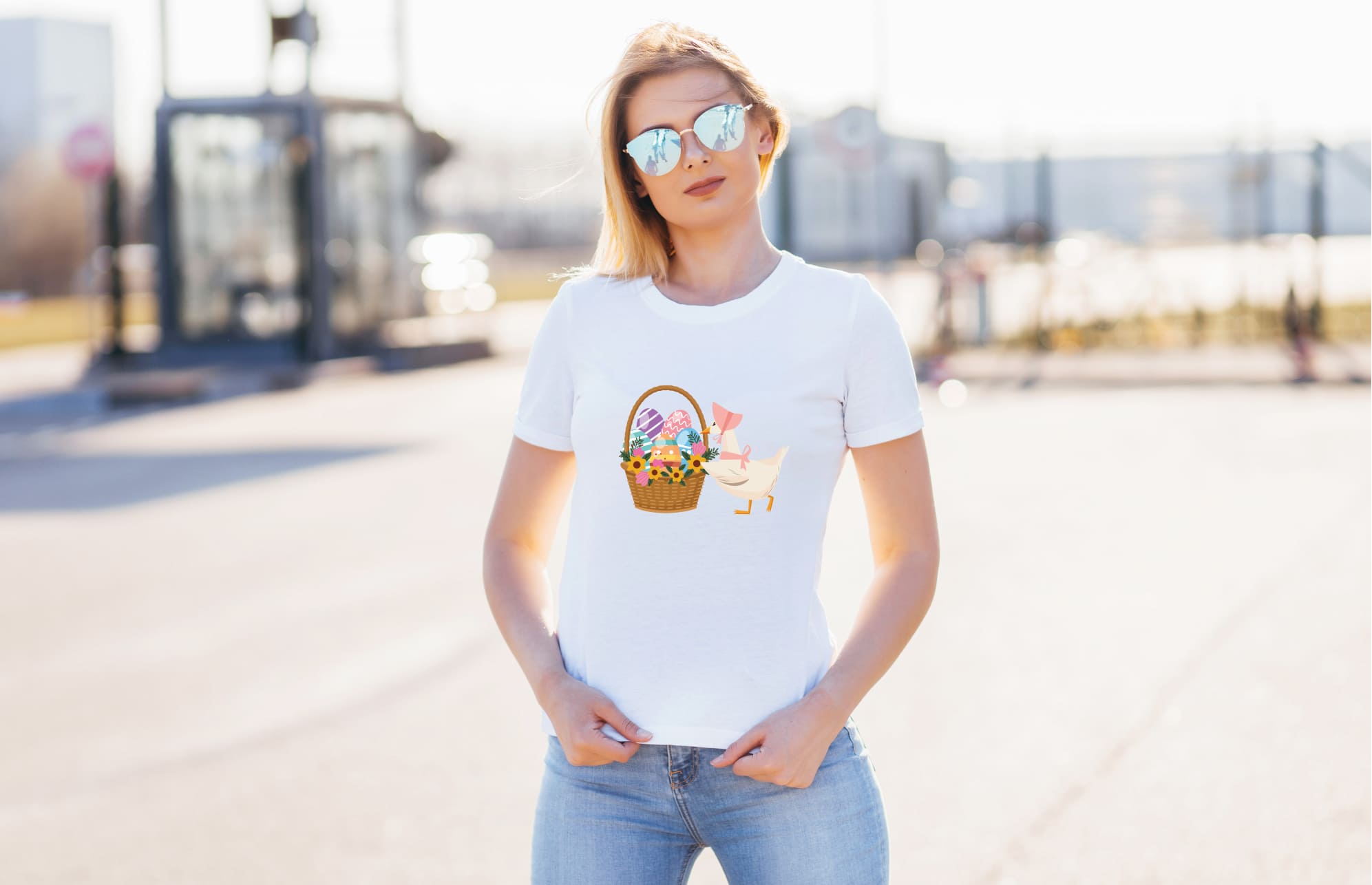 Image of white t-shirt with colorful print of easter eggs and duck.