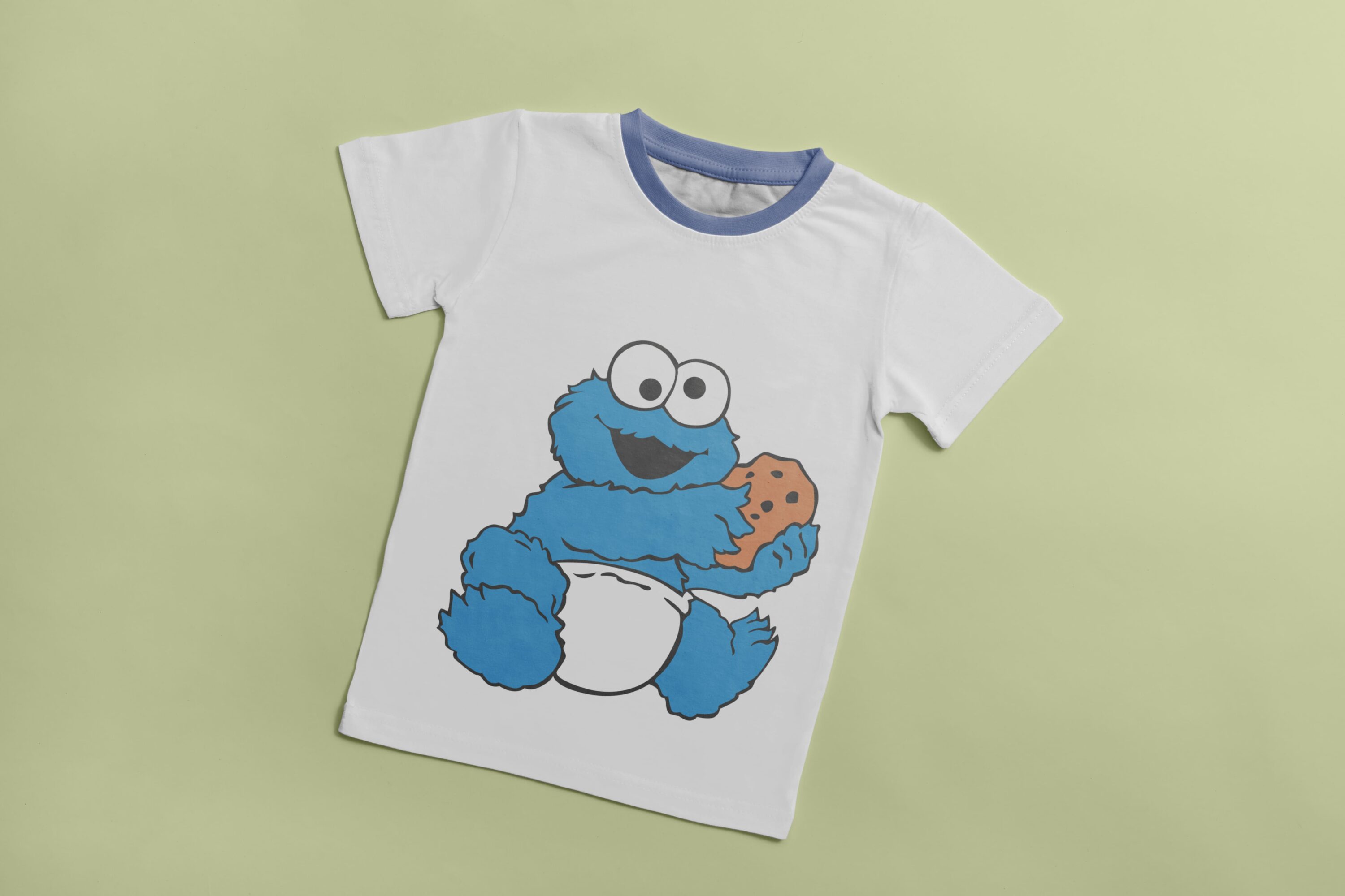 White T-shirt with a blue collar and an image of a blue baby Cookie Monster, holding a cookie.