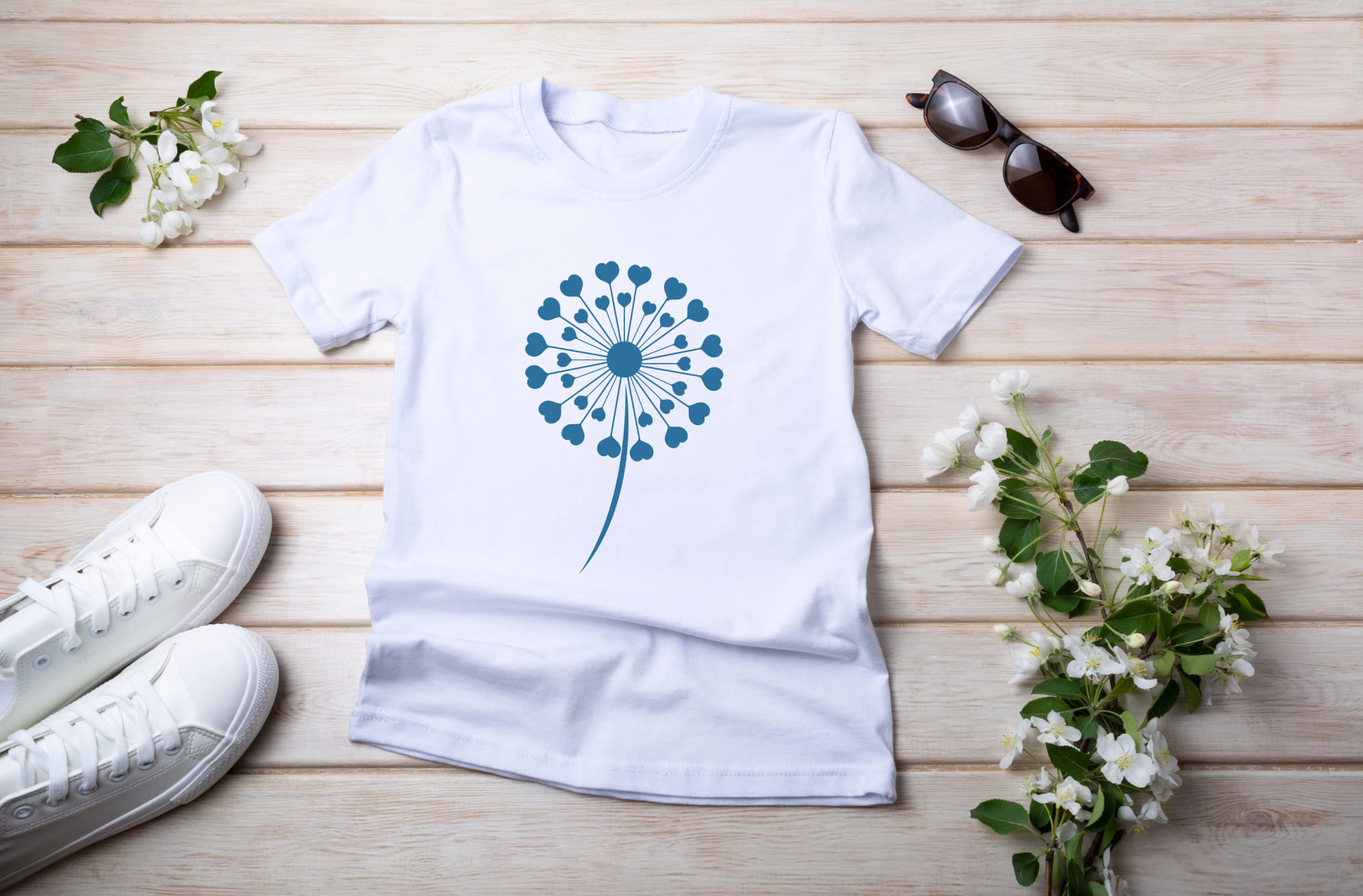 White T-shirt with blue dandelion flower and sunglasses with white sneakers.