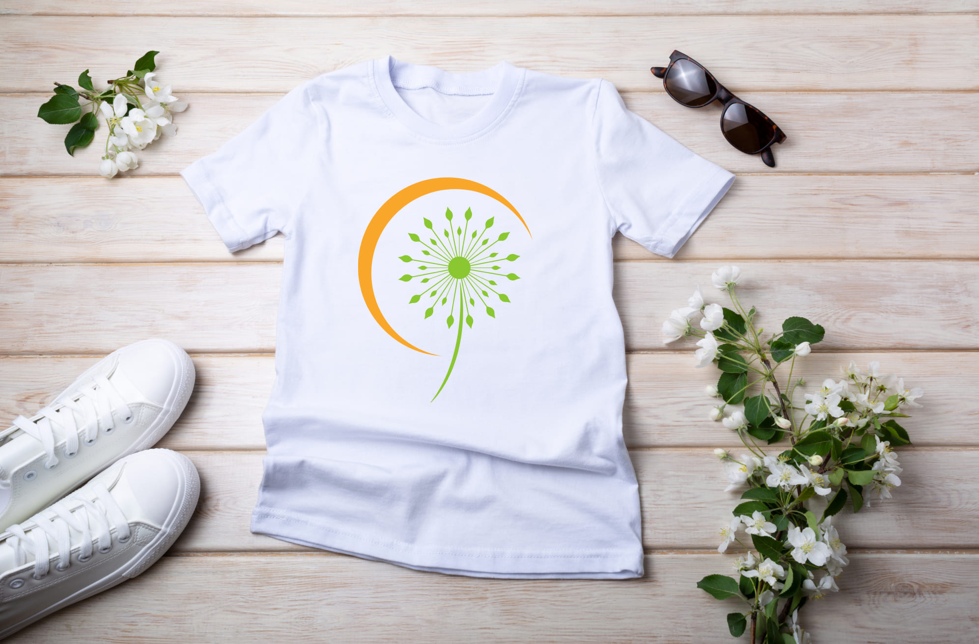 White T-shirt with green and orange dandelion flower and sunglasses with white sneakers.
