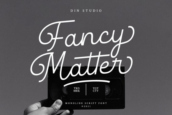 White lettering "Fancy Matter" in script font on a gray background with a black cassette.