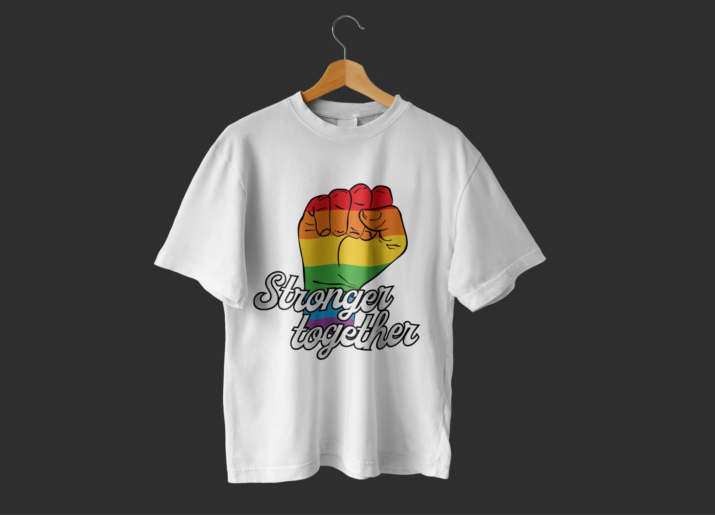 A white t-shirt with an image of a hand in the colors of the LGBT flag and the grey lettering "Stronger together" on a hanger, on a dark gray background.