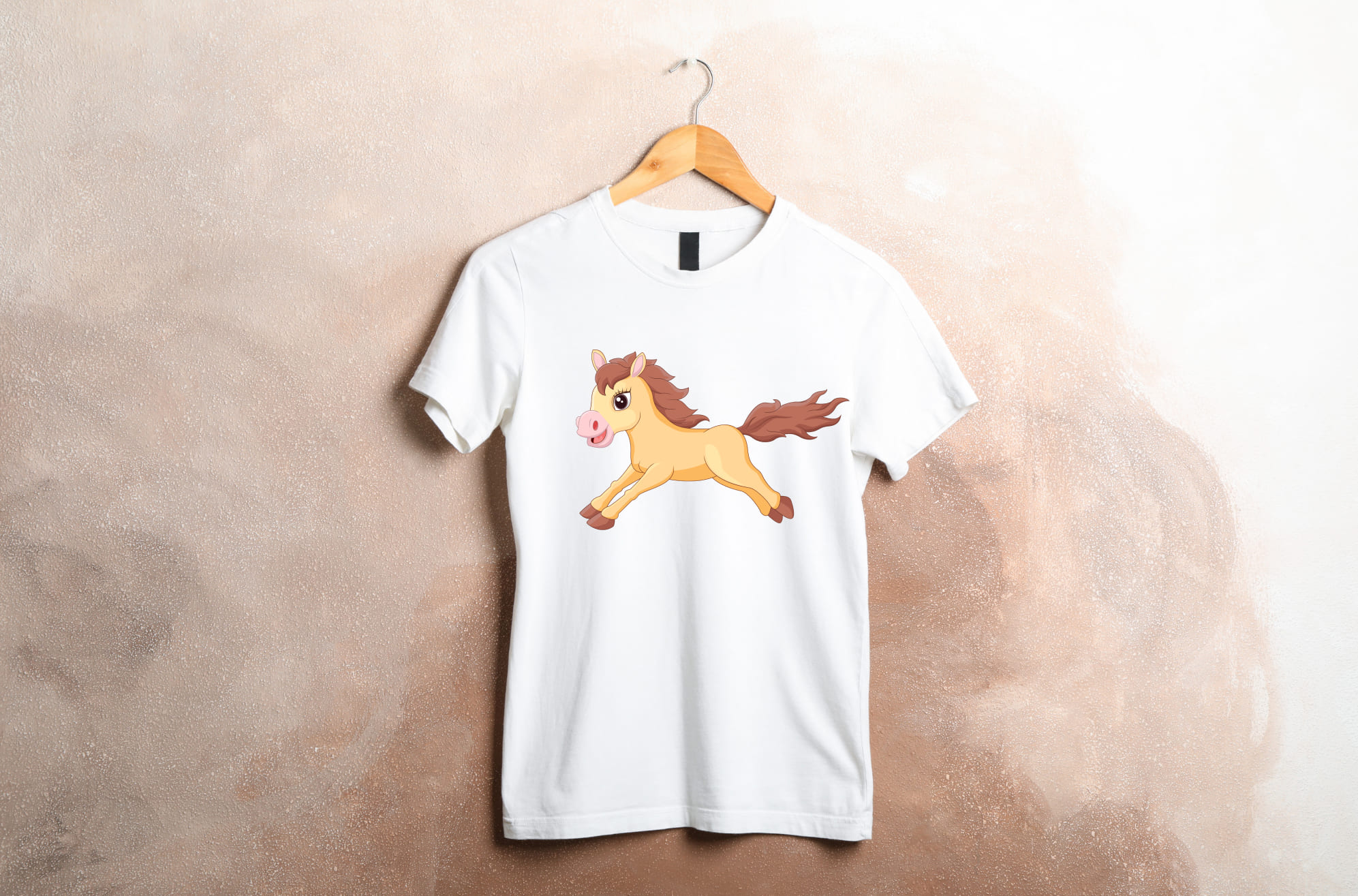White t-shirt with a running horse on a wooden hanger on a beige background.