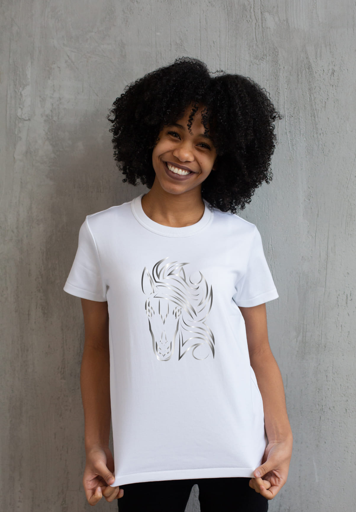 White t-shirt with a silver horse face on a girl.