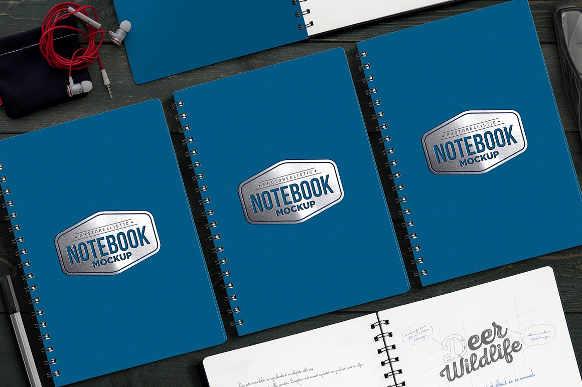 3 blue mockups notebook with "Notebook Mockup" lettering on the table.