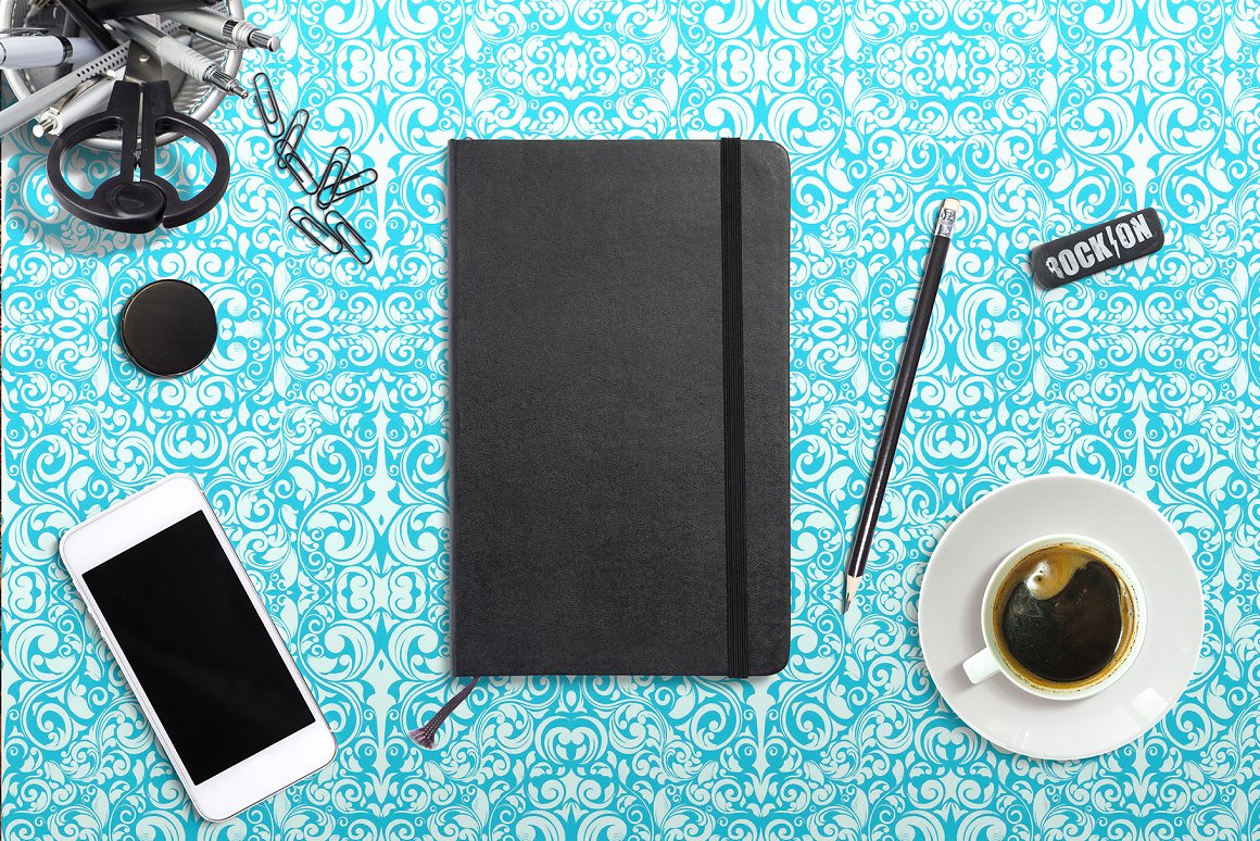 Black notebook mockup, mockup Iphone, a cup of coffee and different stationery on a light blue abstract background.