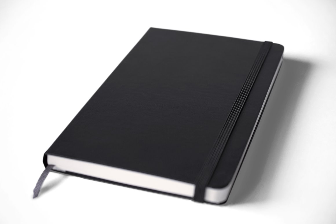Black lying notebook mockup with a black rubber band bookmark on a white background.