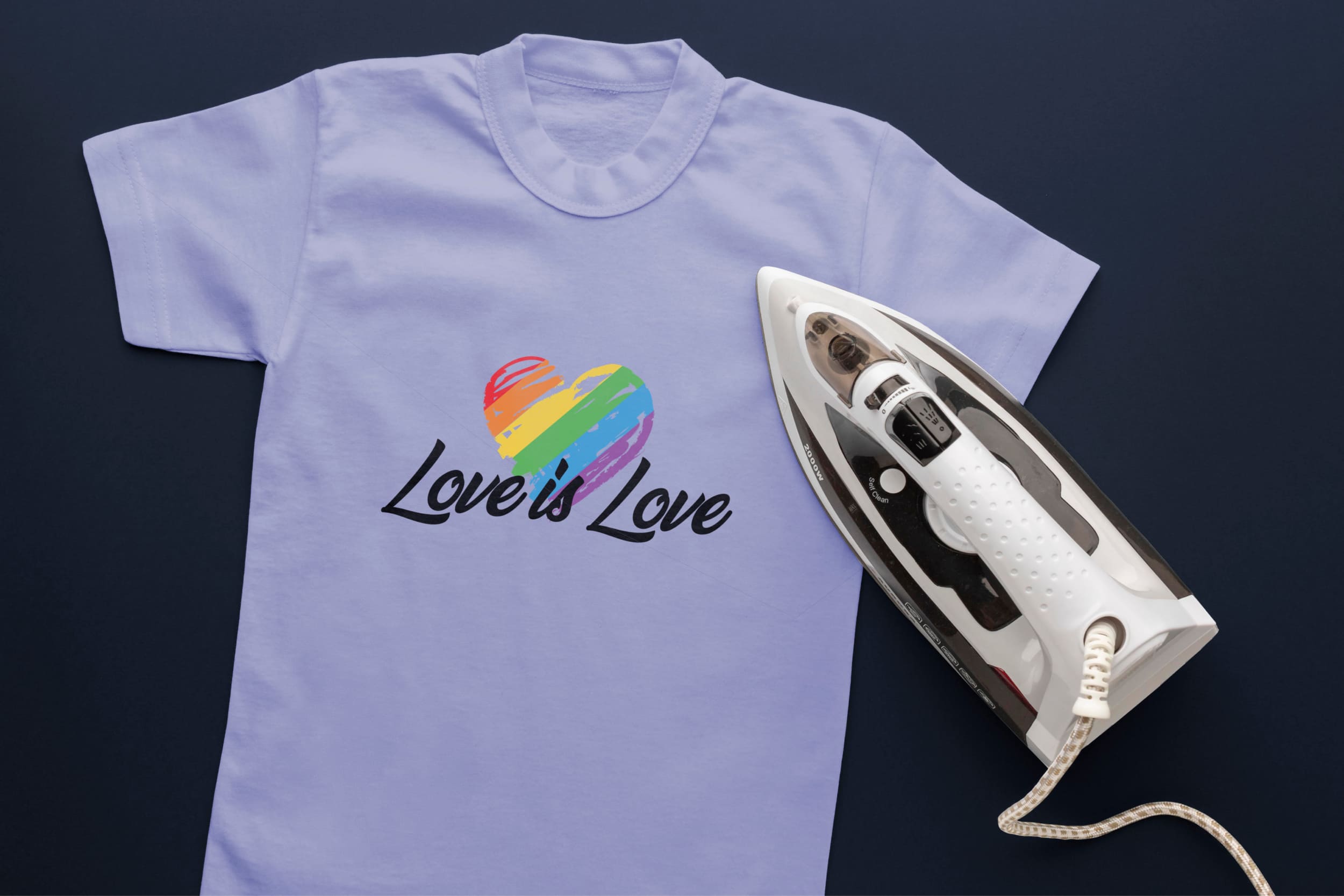 Light blue t-shirt with black lettering "Love is Love" and a heart in LGBT colors and an iron.