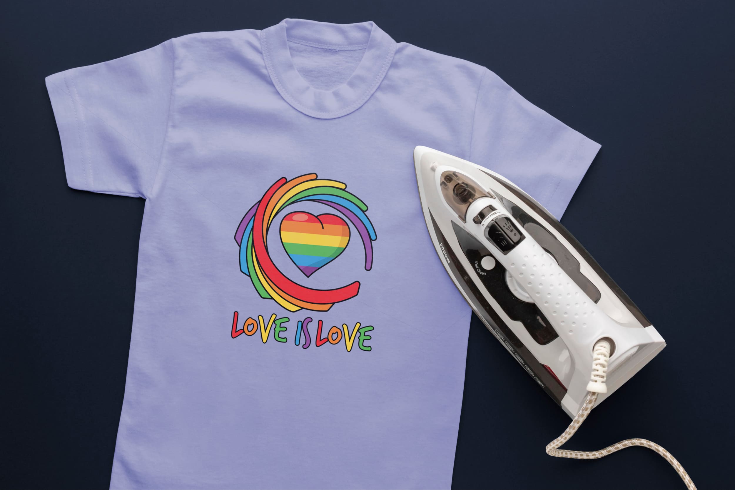 Light blue T-shirt with abstractions in LGBT colors, heart in LGBT colors, lettering "Love is Love" in LGBT colors and an iron.