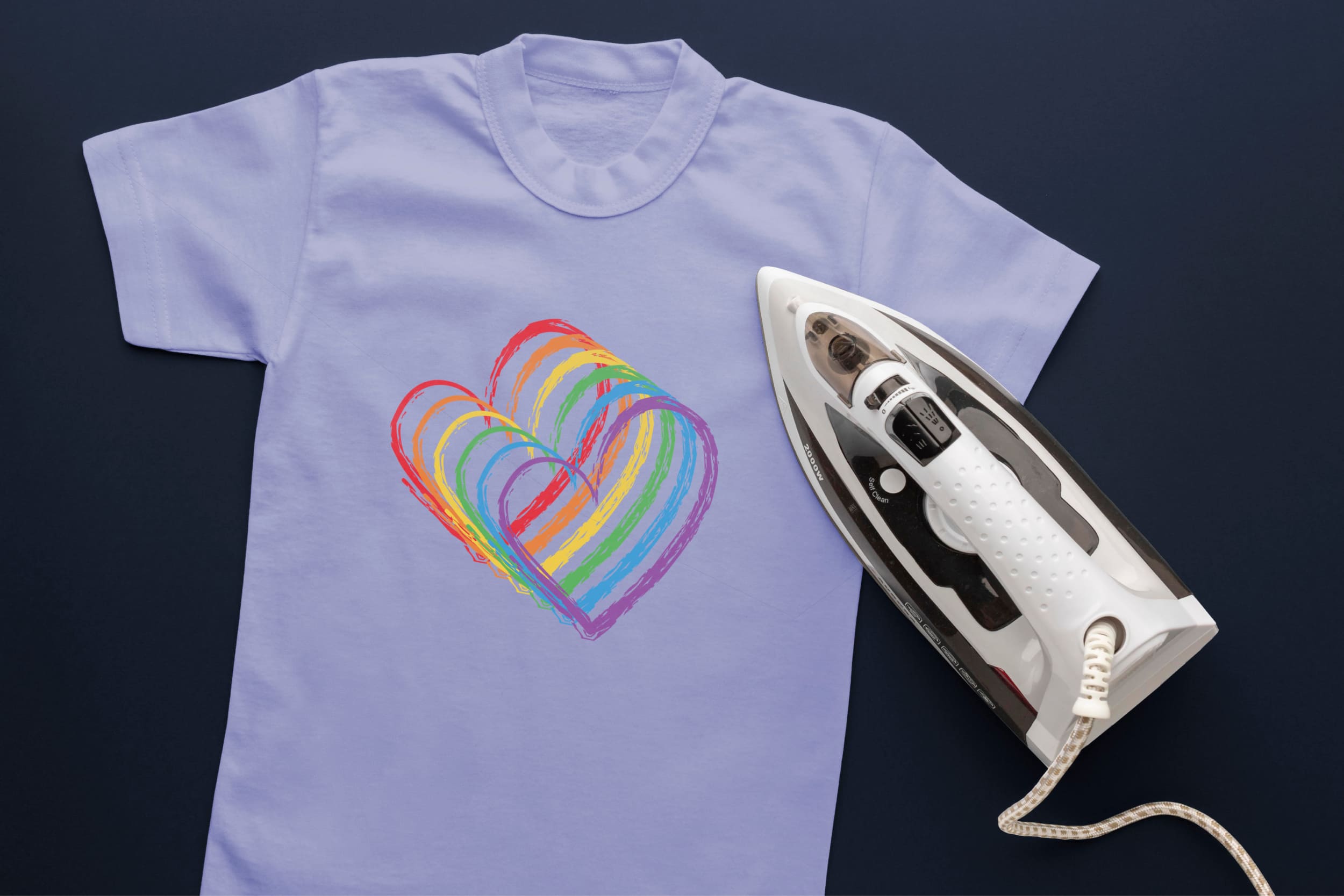 Light blue t-shirt with hearts in LGBT colors and an iron.