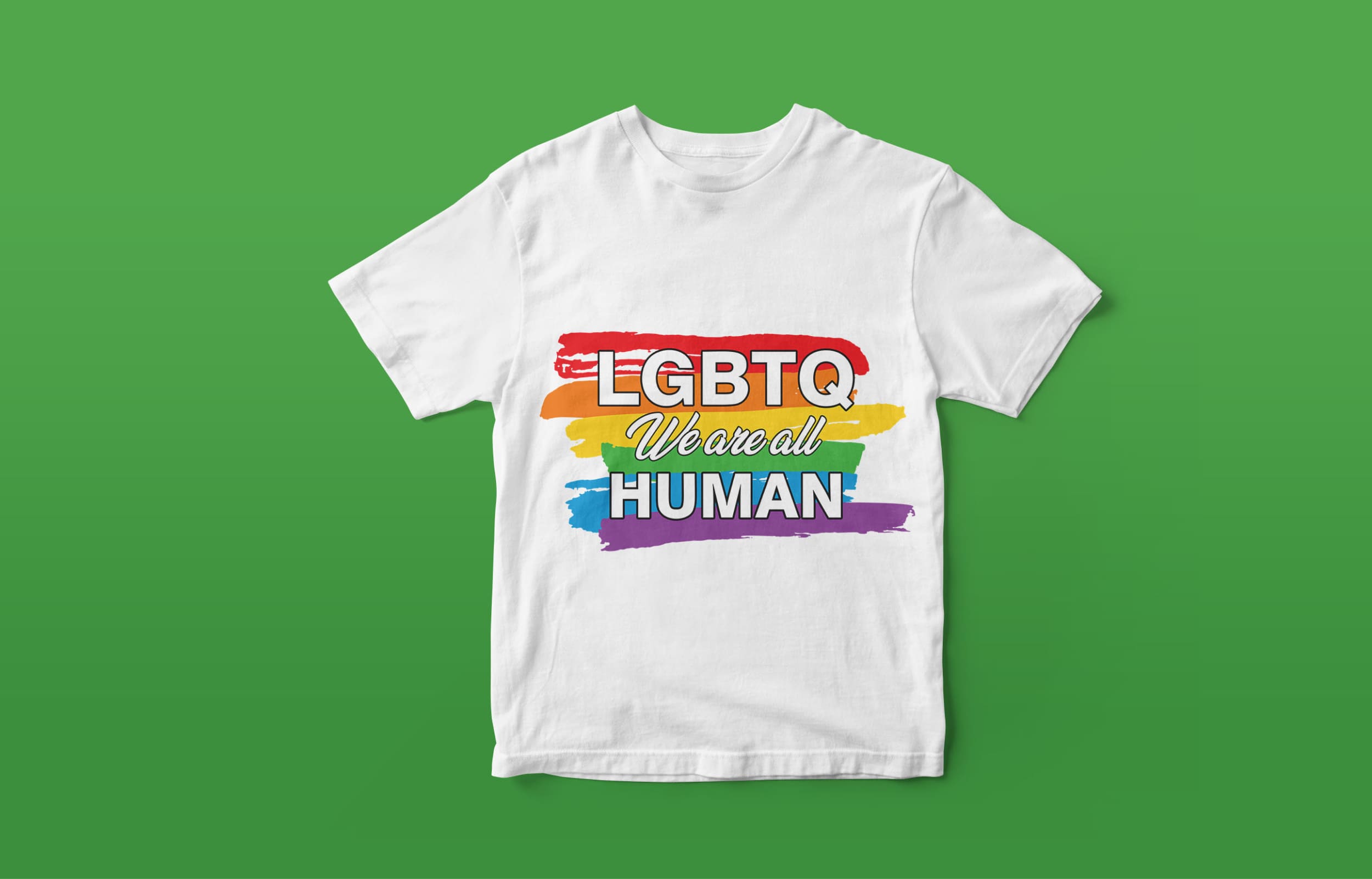 A white T-shirt with a white lettering "LGBTQ we are all human" against the background of the LGBT flag, on a green background.