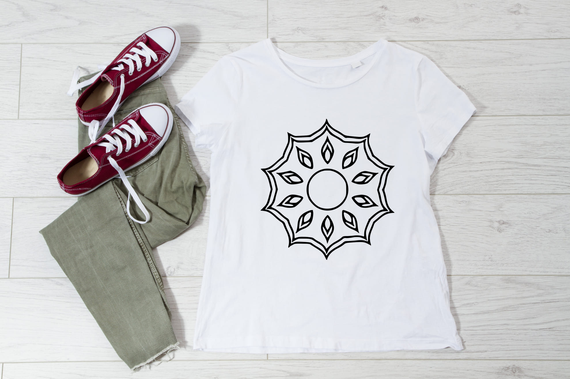 Minimalistic mandala illustration on the white t-shirt.