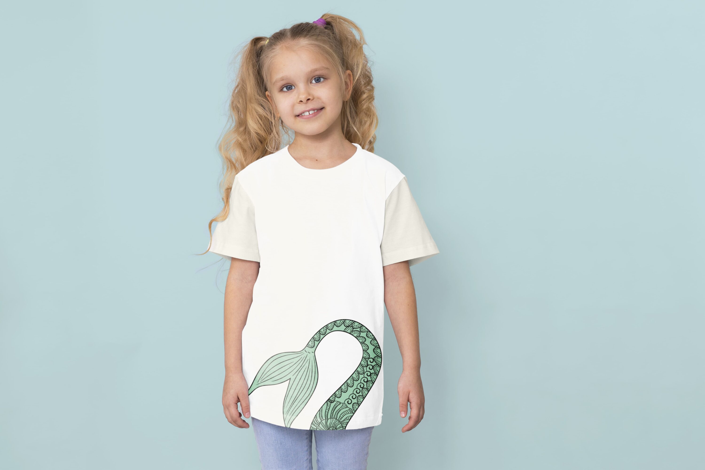 Delicate mermaid tail on the white t-shirt.