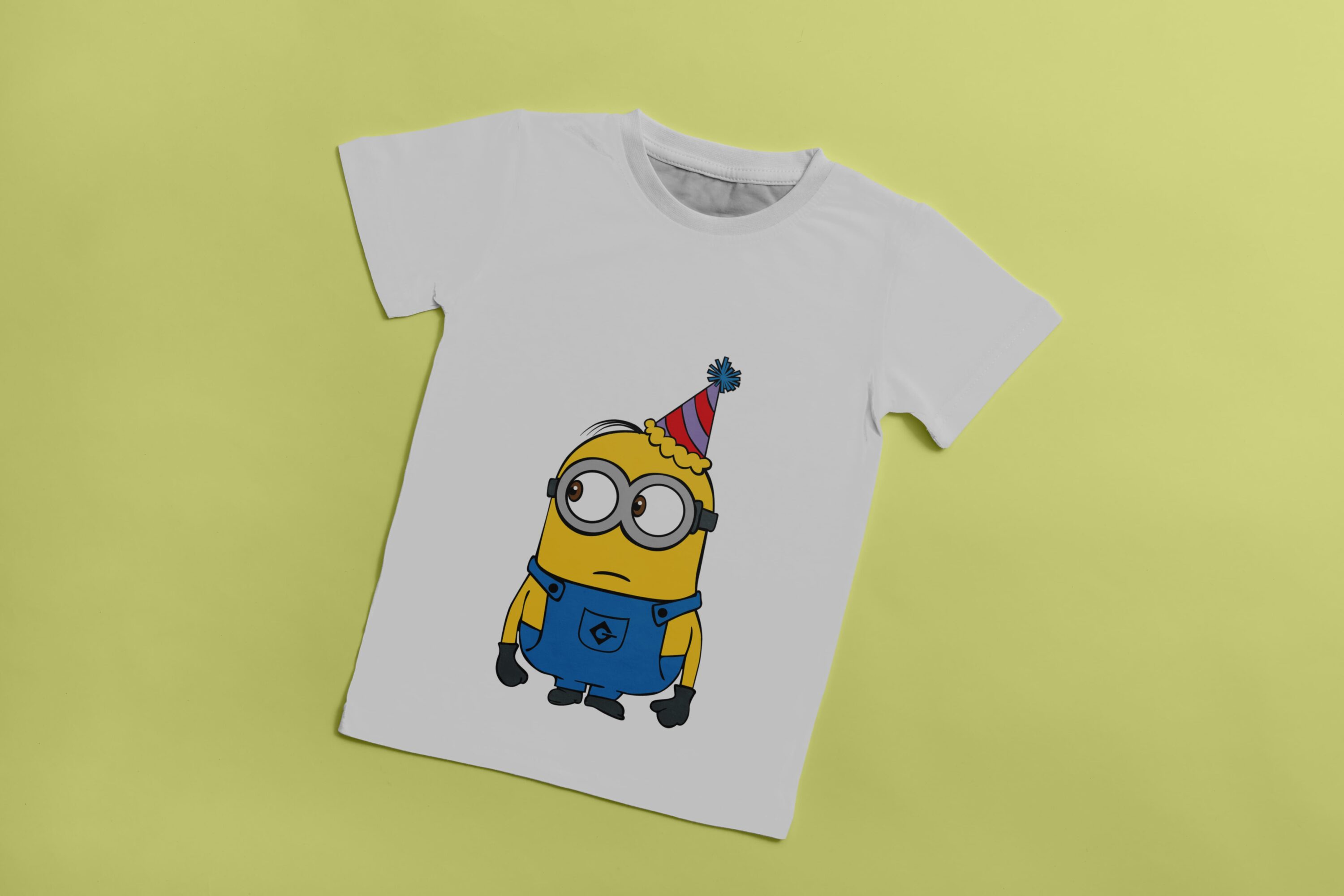 White T-shirt with an image of a sad Minion with a party hat.