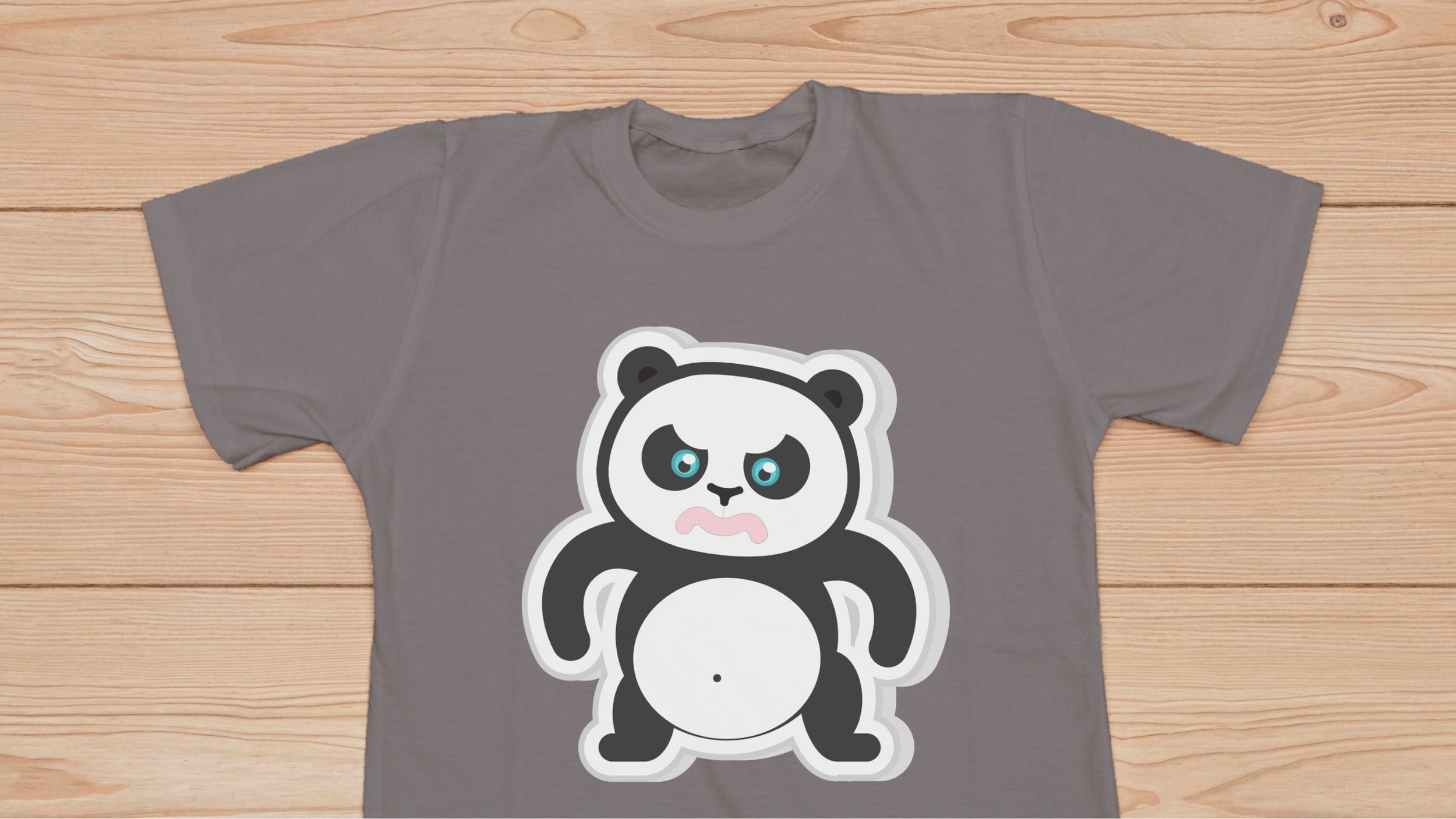 Gray t-shirt with angry panda bear on a wooden background.