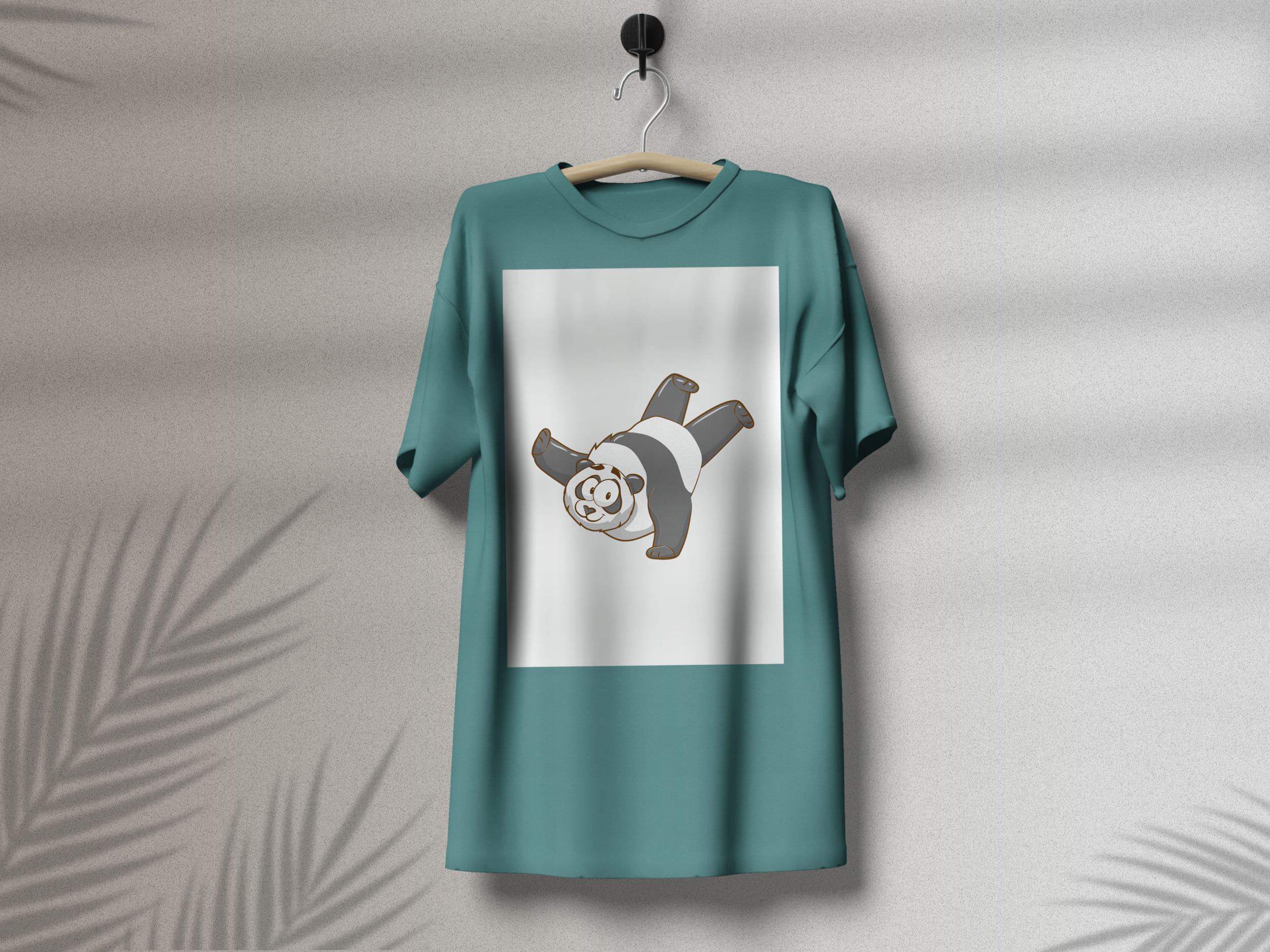 Turquoise t-shirt with a crazy panda on a white background, on a hanger on a gray background