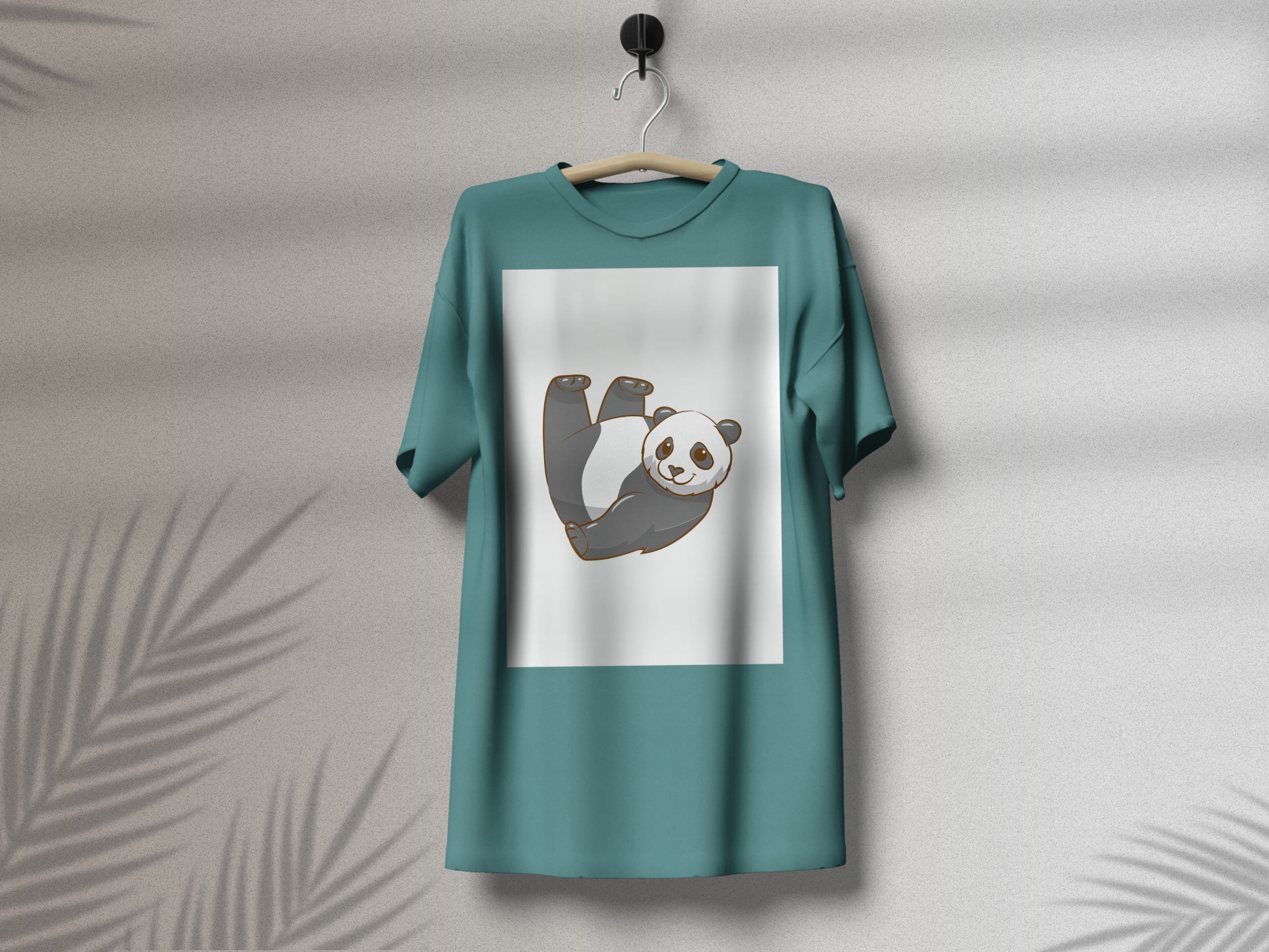 Turquoise t-shirt with a cute panda on a white background, on a hanger on a gray background