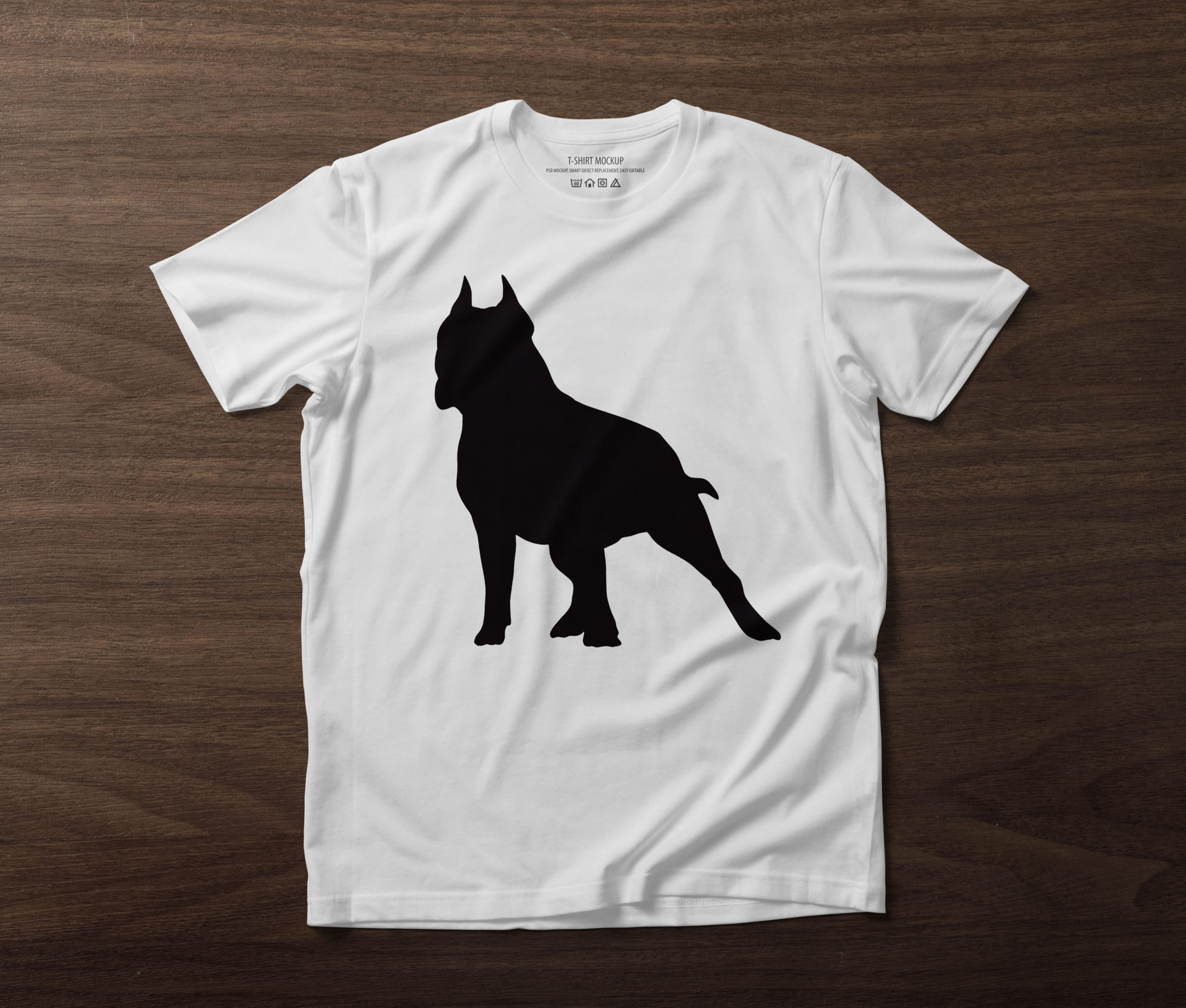 White t-shirt with a black pitbull silhouette on the table.