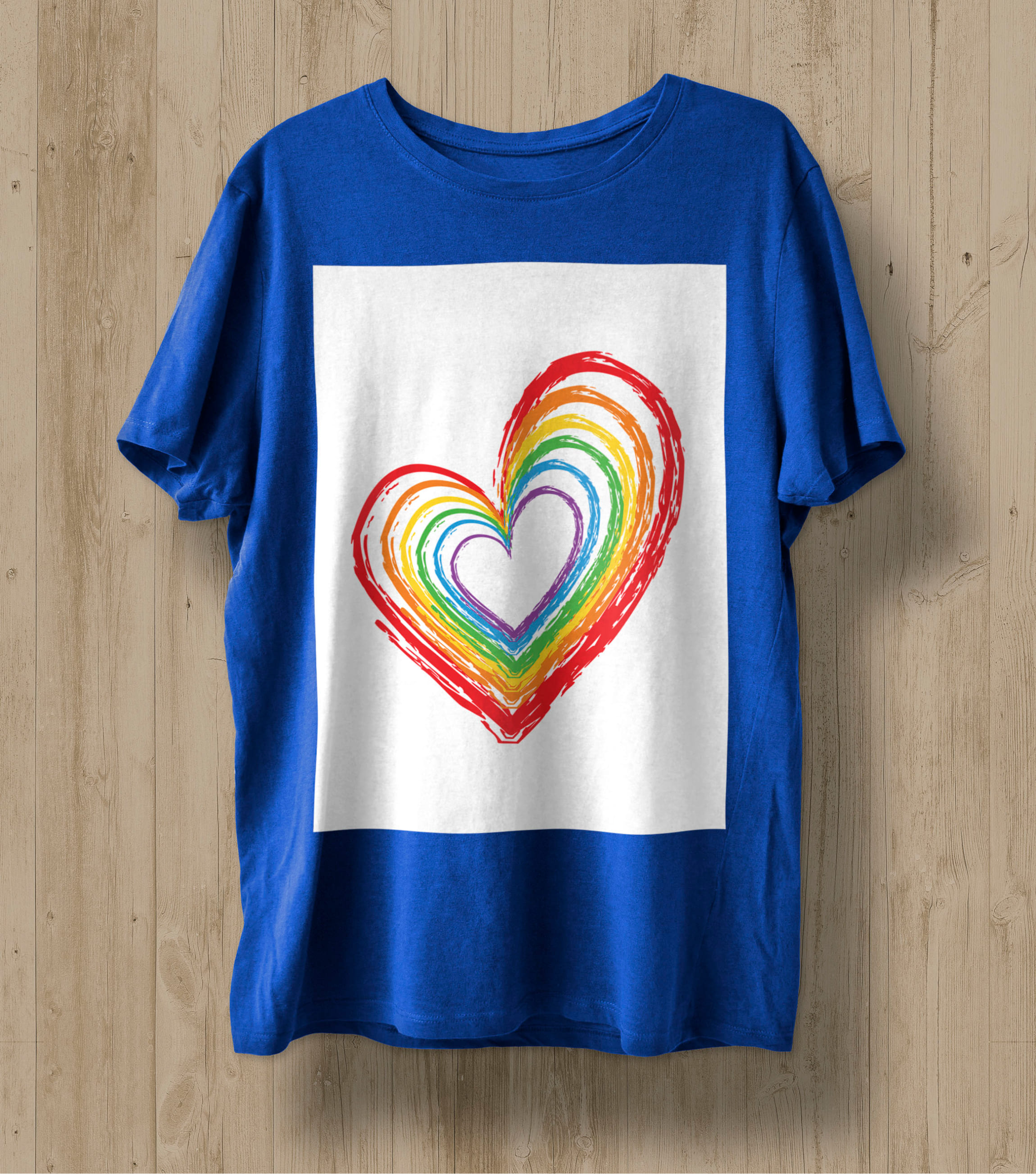Blue t-shirt with a heart in the colors of the LGBT flag in a white rectangle.
