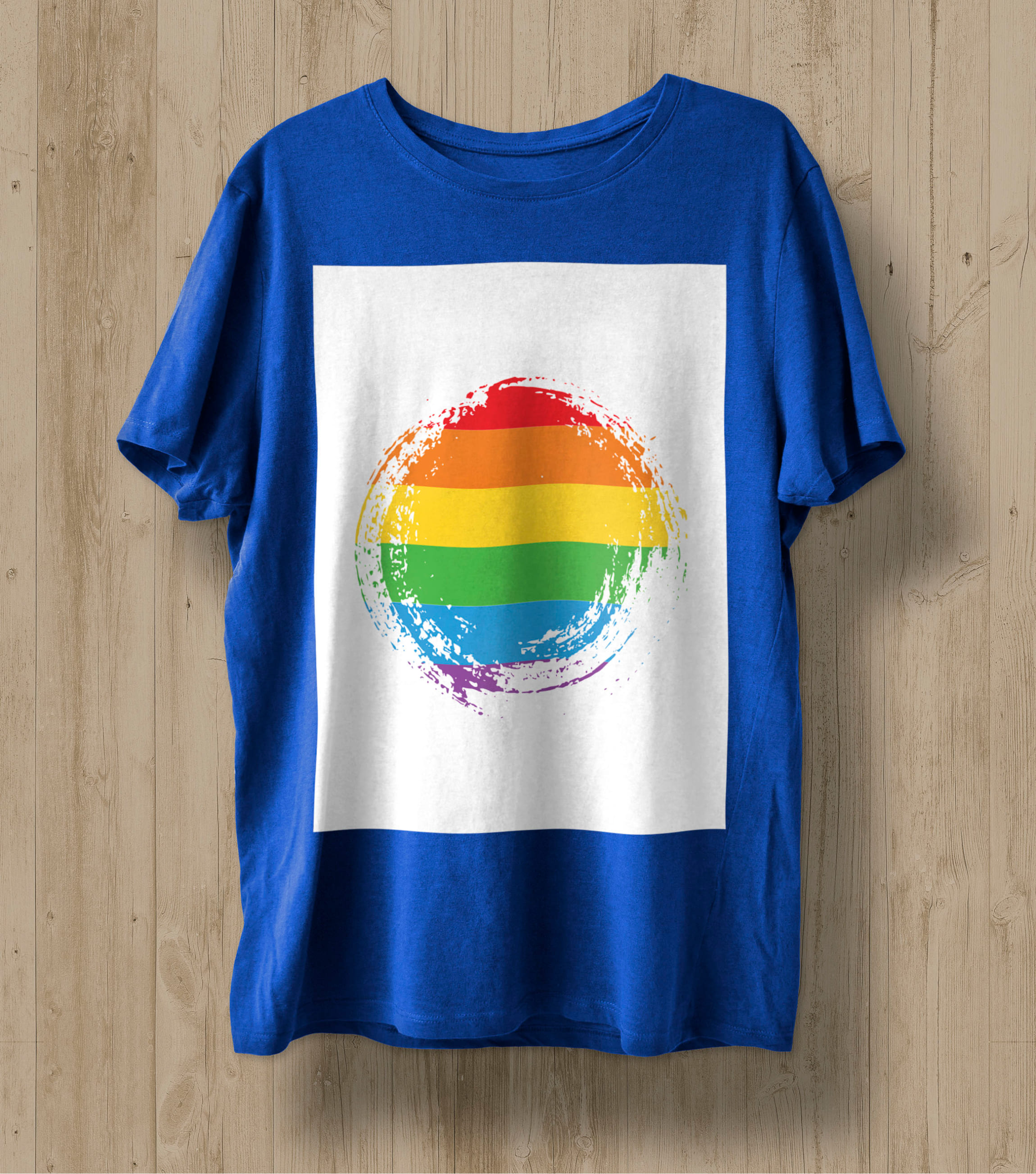 A blue t-shirt with a circle of the LGBT flag in a white rectangle.