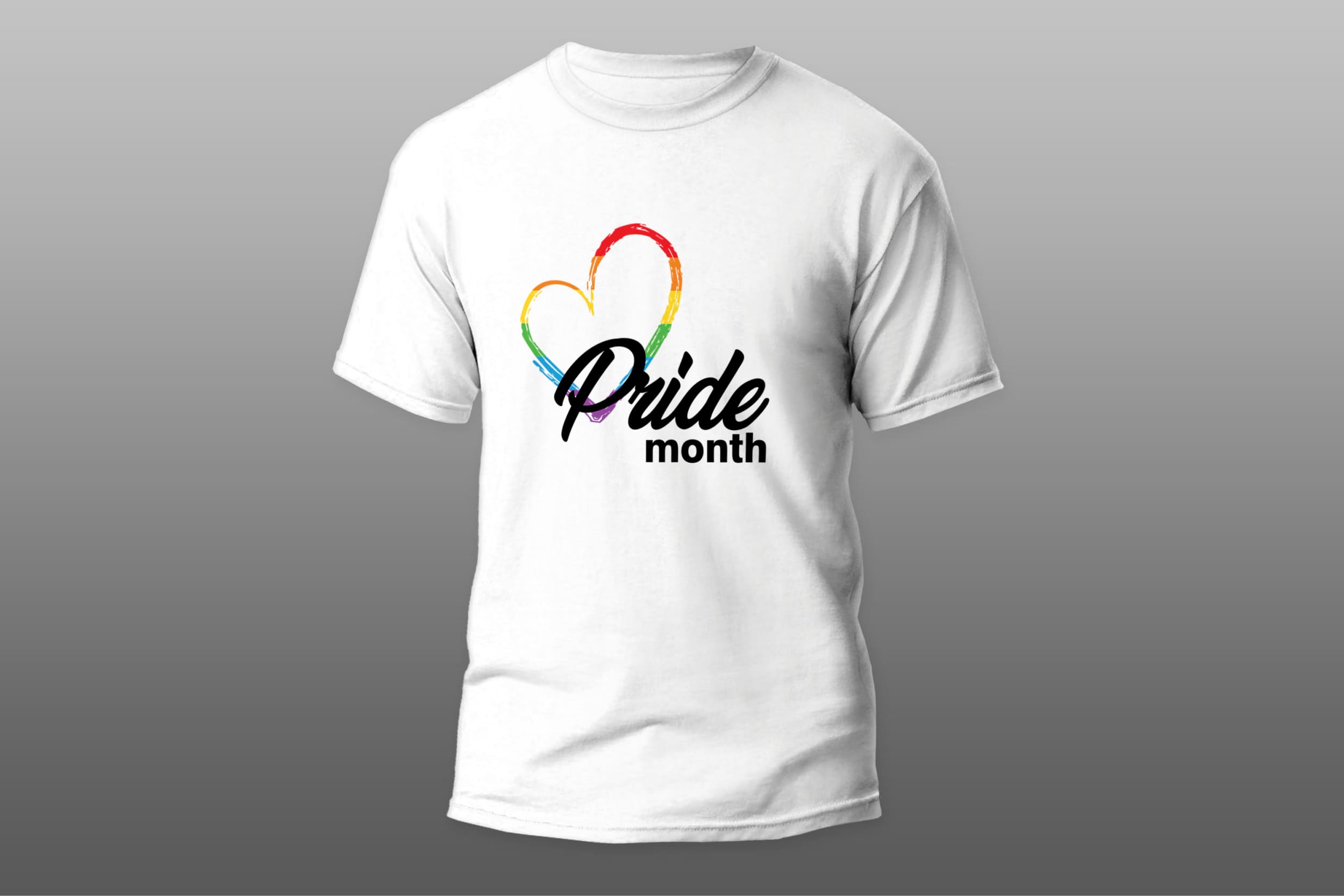 White t-shirt with a black "Pride month" lettering and a heart in the colors of the LGBT flag on a gray background.